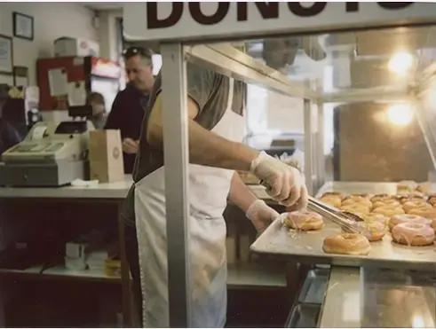 A food service worker behind the counter