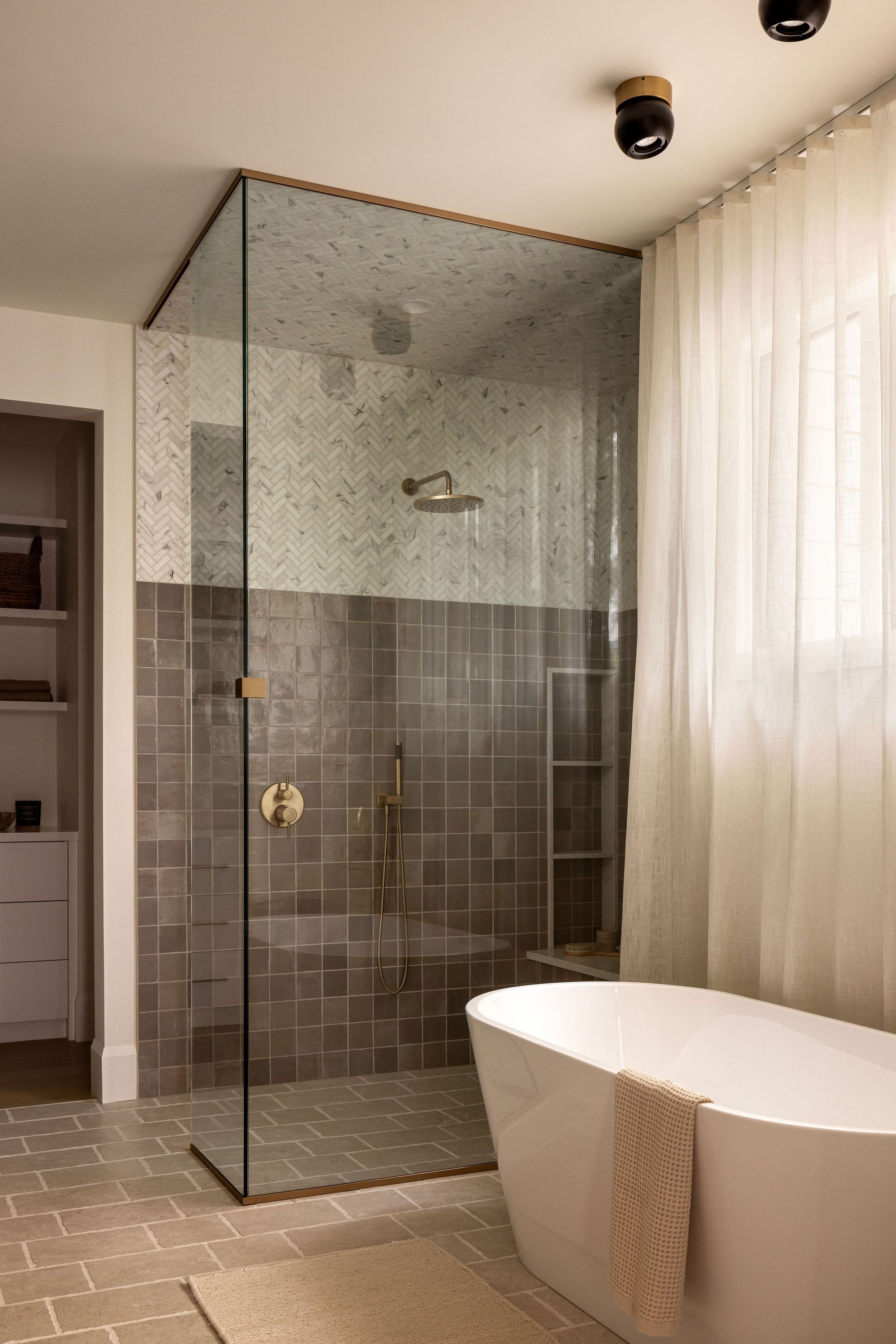 Glass shower and freestanding tub in The Charlotte home