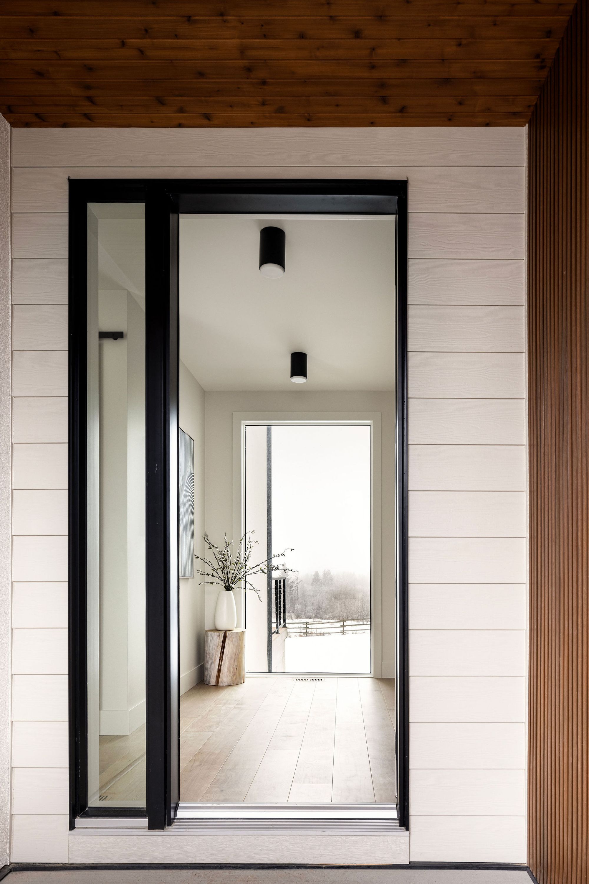 Front entry with a glass door in the Priddis home