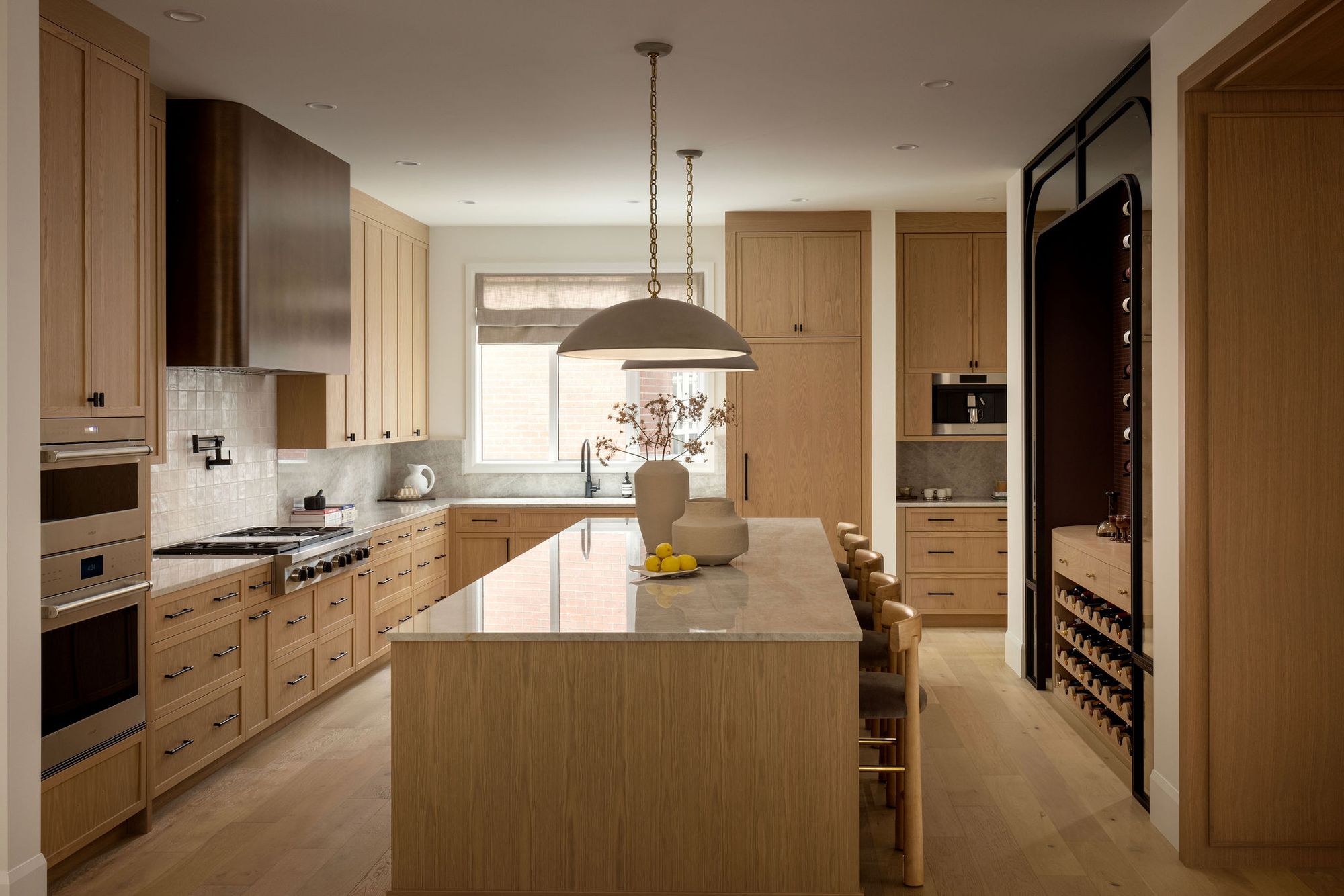 Kitchen with wood cabinets and island in The Charlotte home