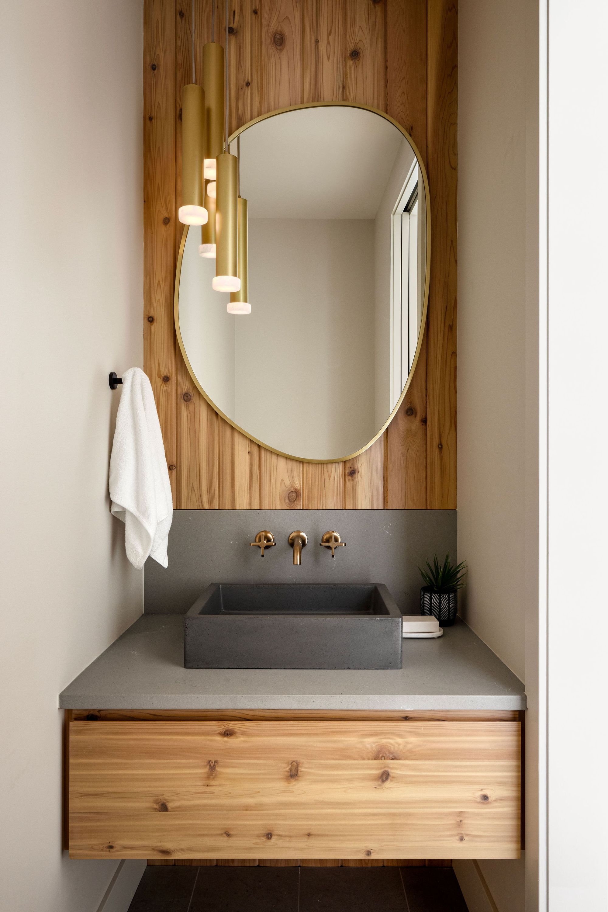Powder room with a cedar feature wall in the Priddis home