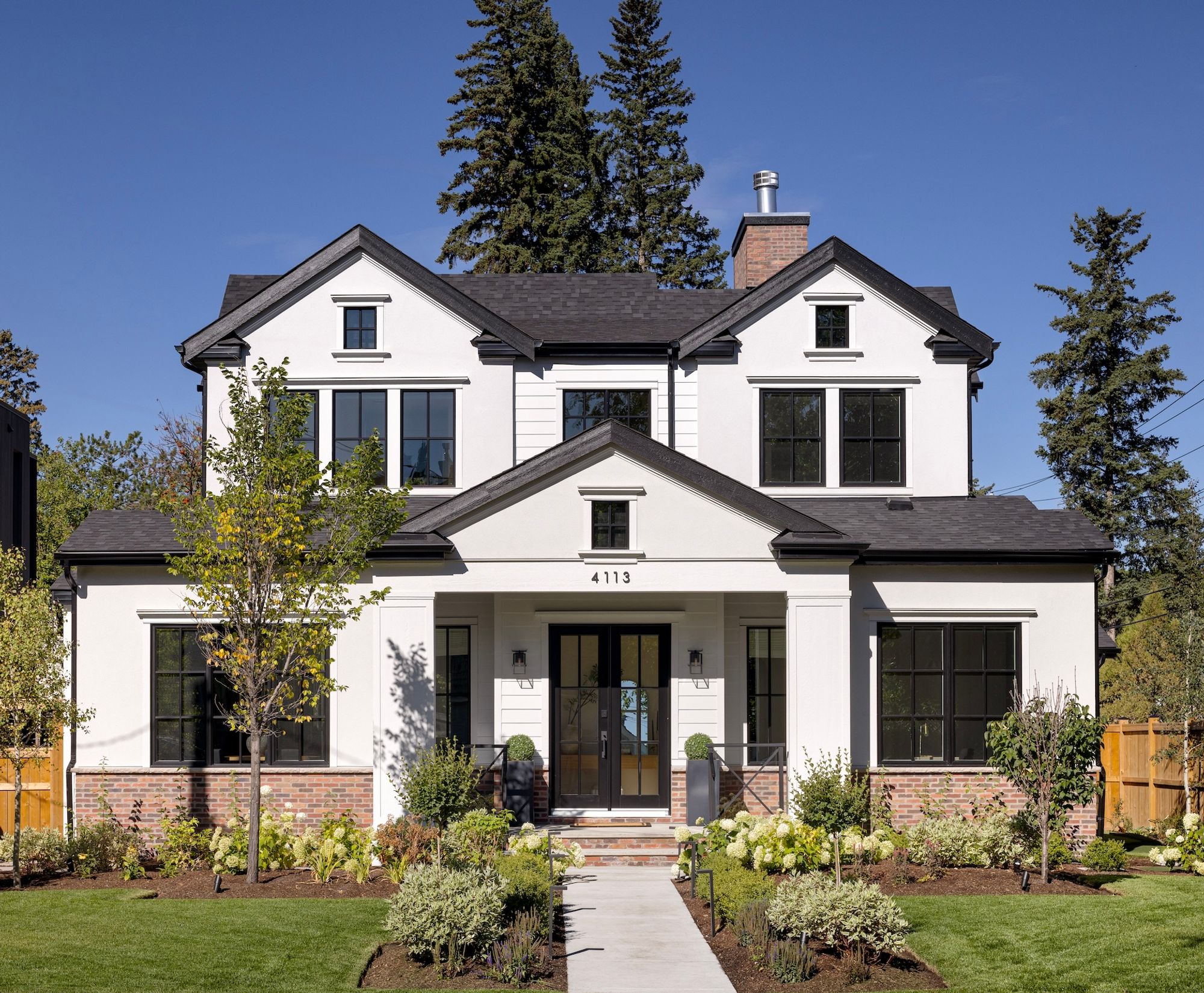 Front exterior of the Riverdale home with gables and a covered porch