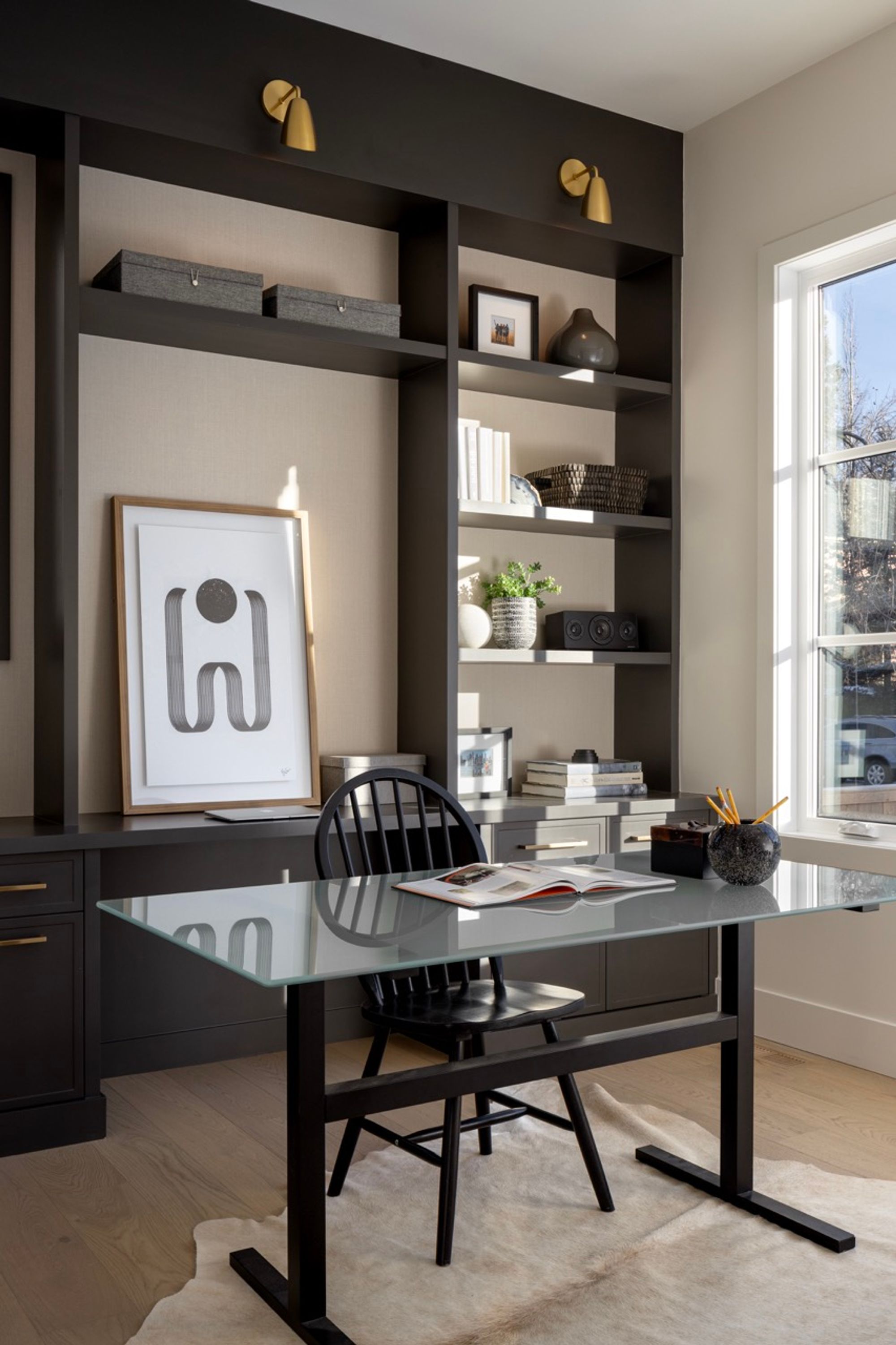 Home office with dark built-in shelving in the Riverdale home
