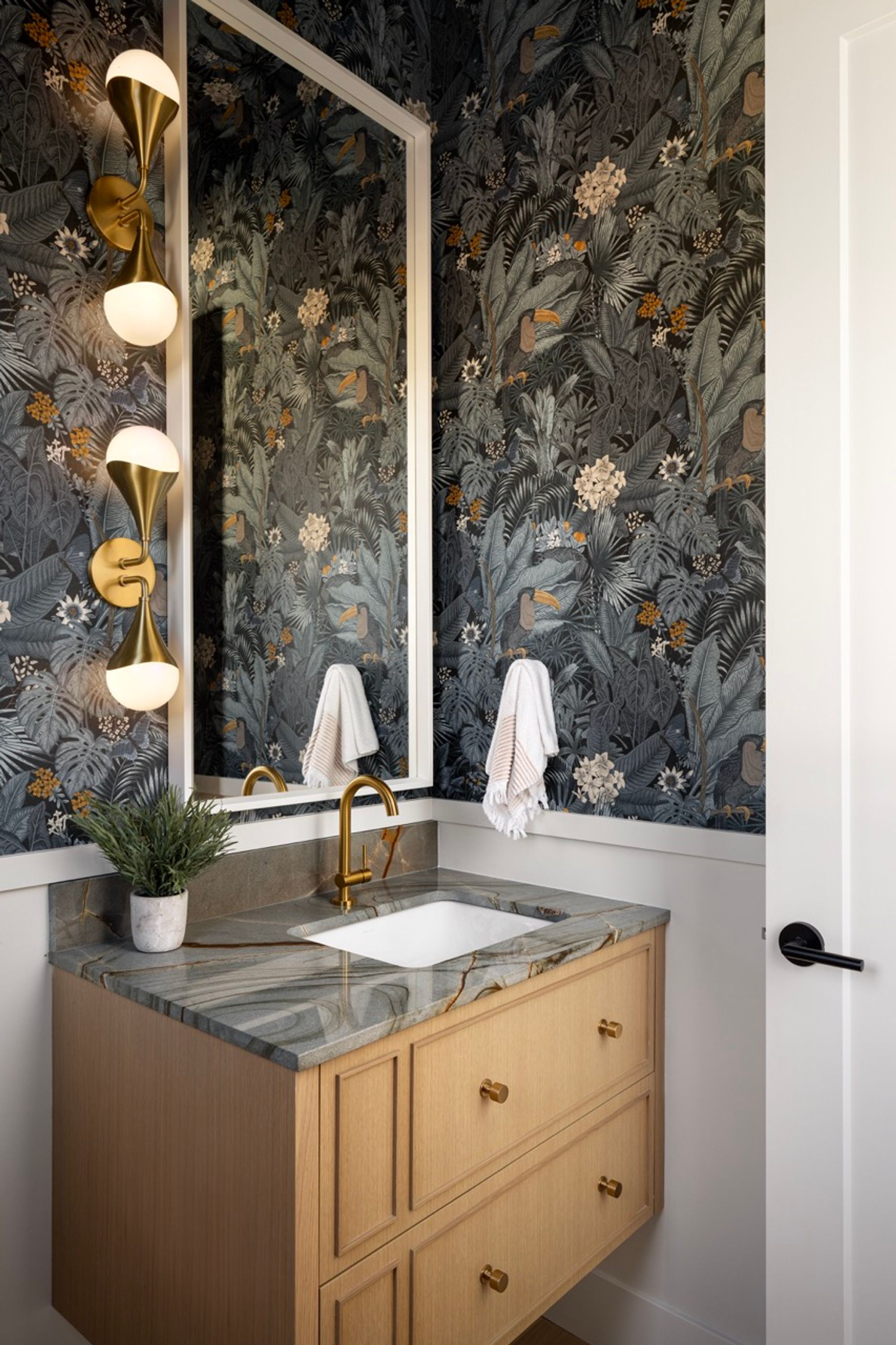 Powder room with jungle wallpaper in the Riverdale home