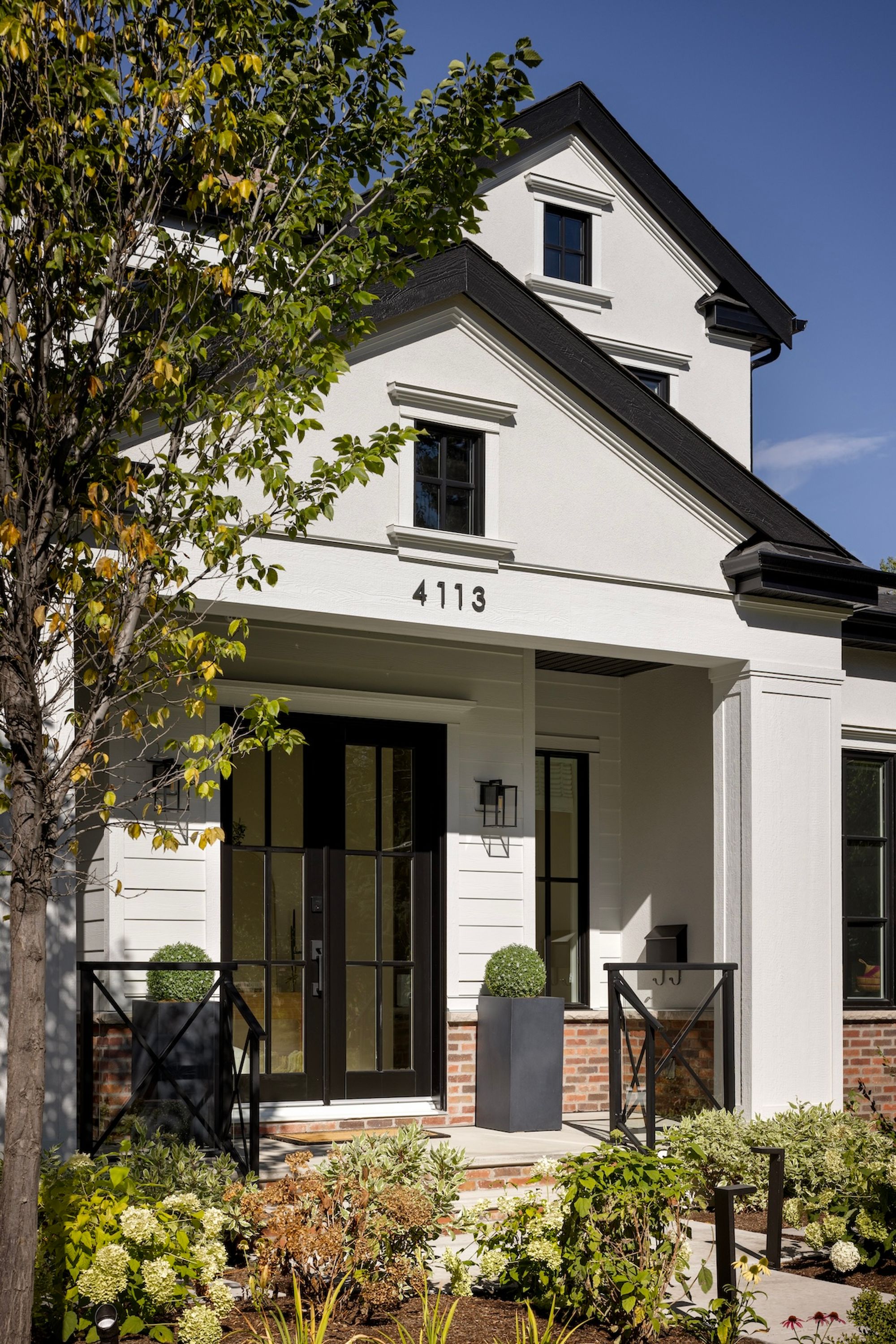 Covered porch and double front doors of the Riverdale home