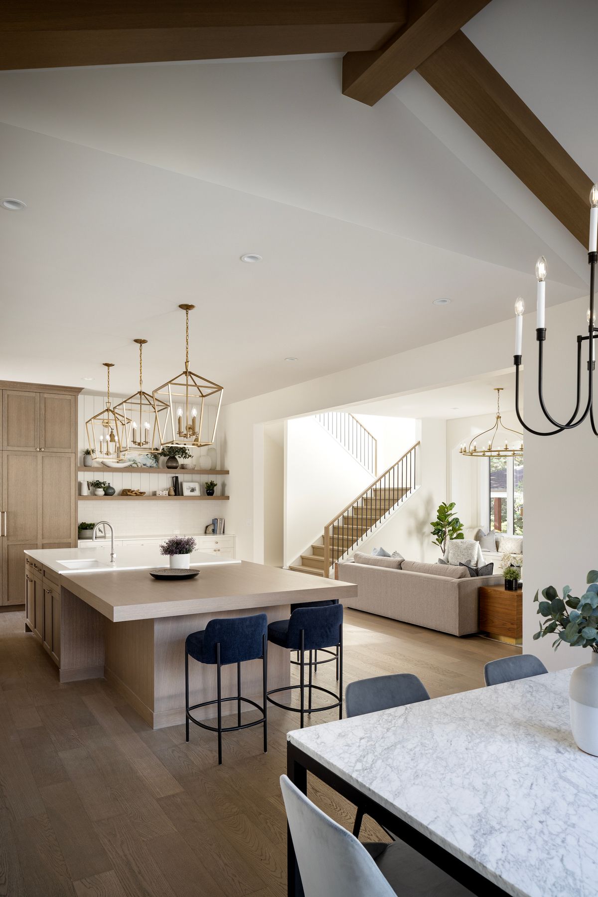 Open kitchen with exposed beams and a large island