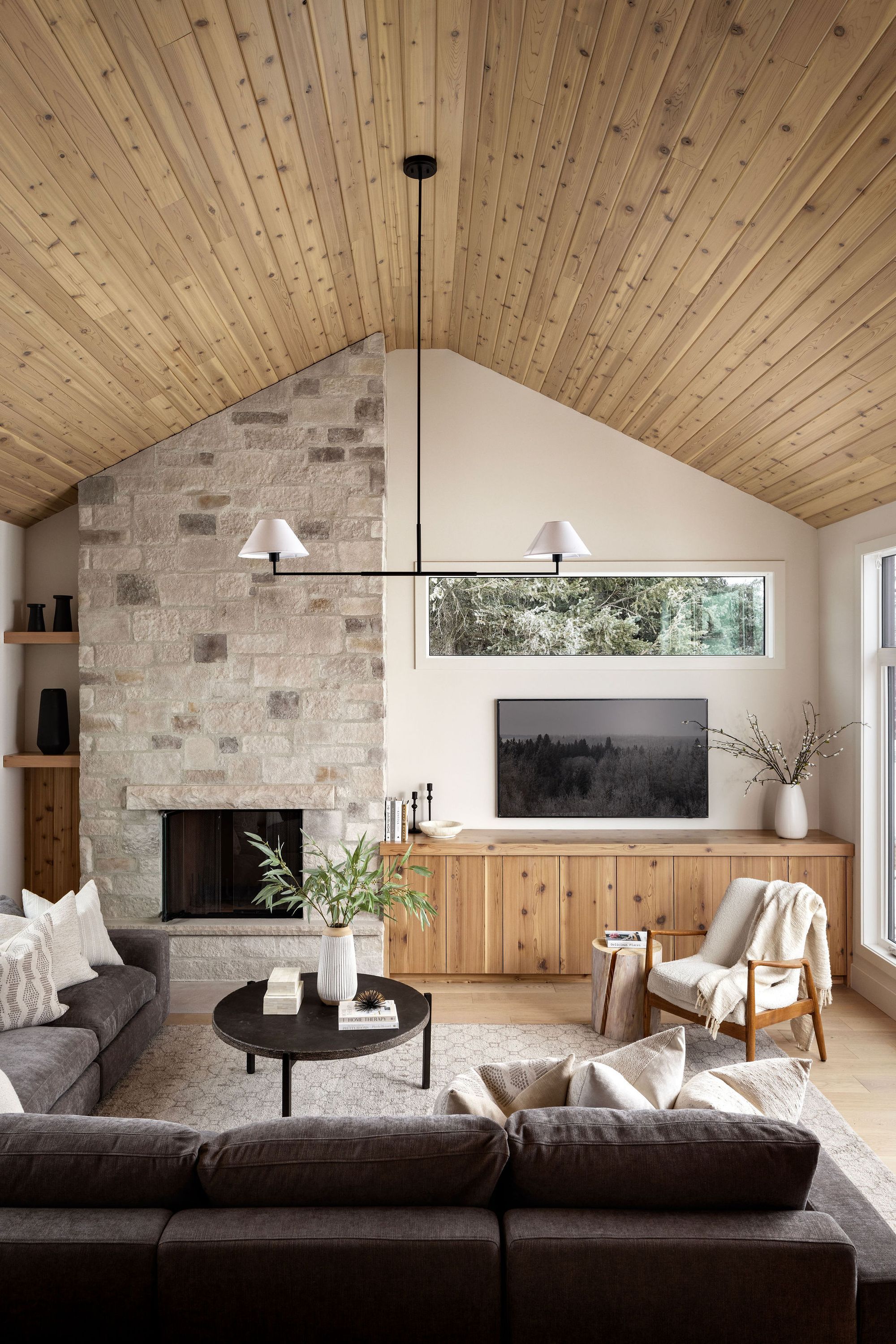 Stone fireplace and vaulted ceiling in the Priddis living room