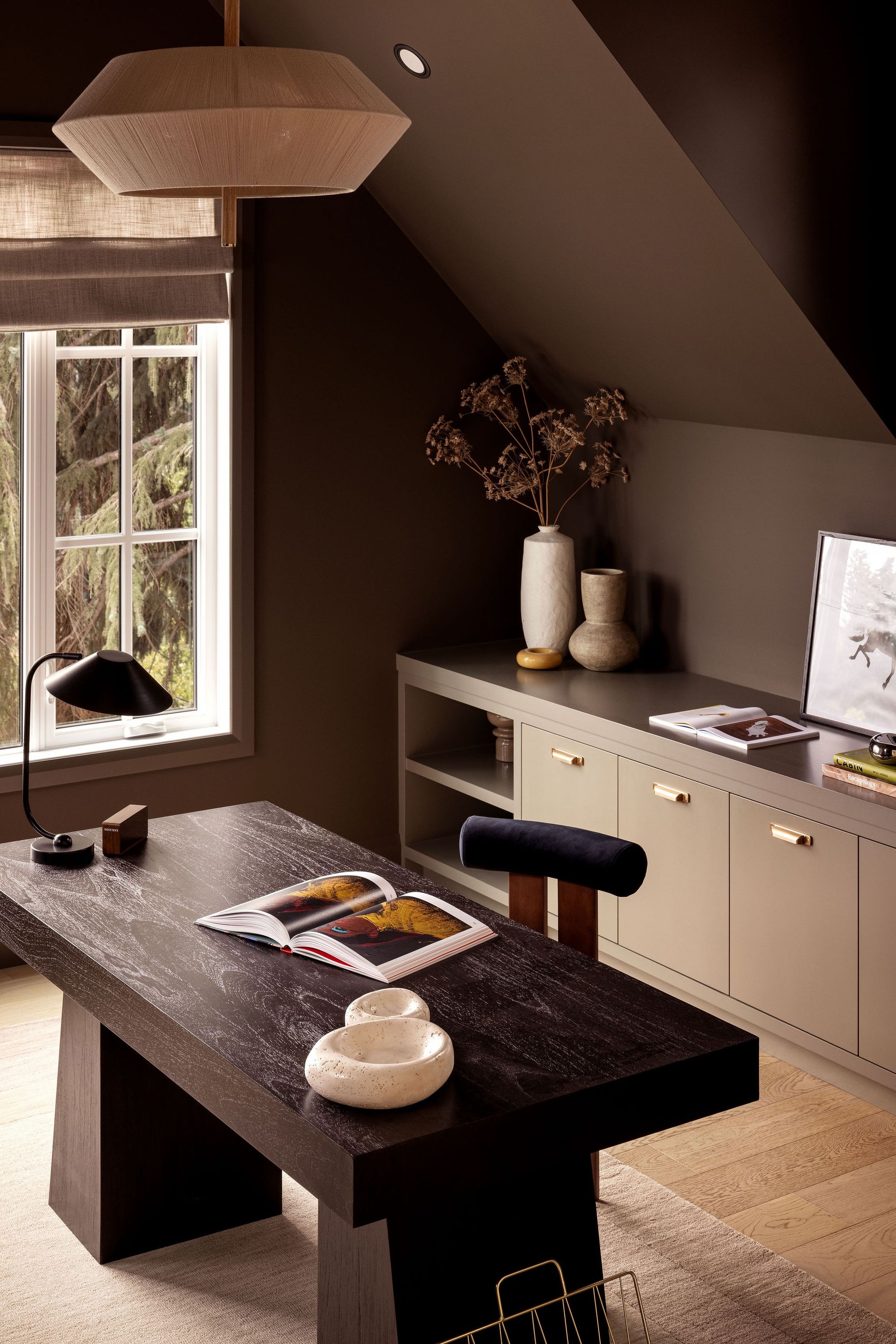 Home office desk beside a window in The Charlotte home