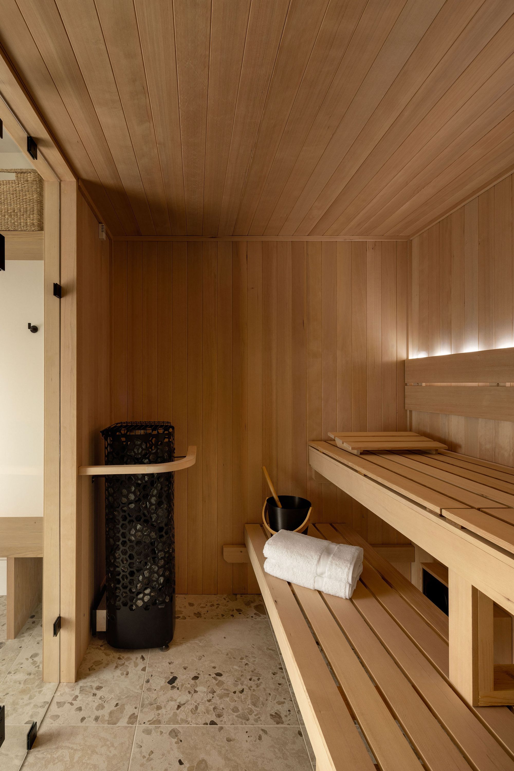 Sauna with wood benches in The Charlotte home