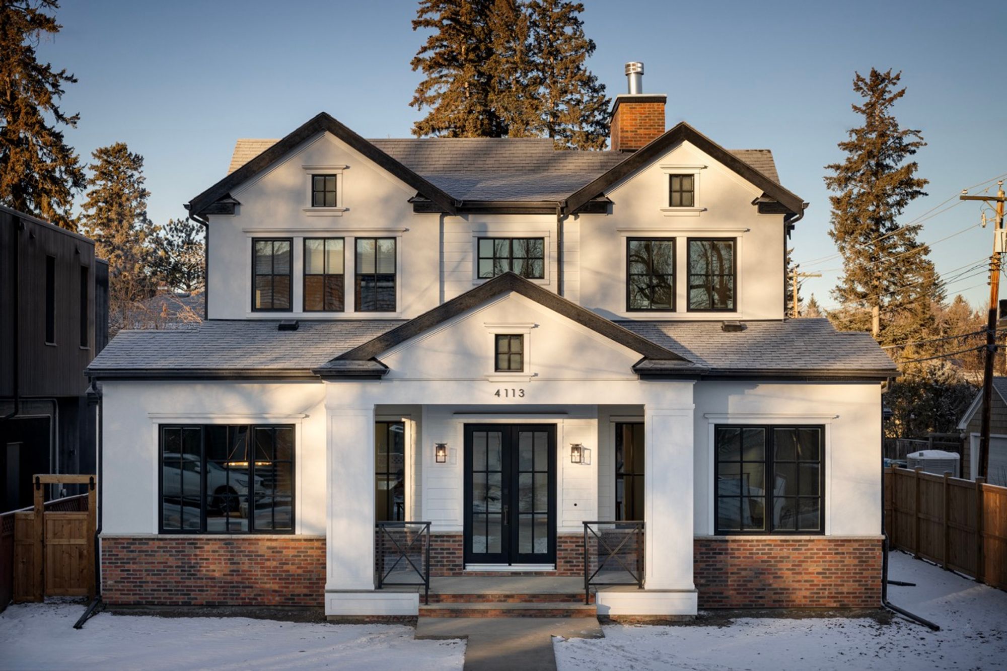 Front exterior with brick base in winter light in the Riverdale home