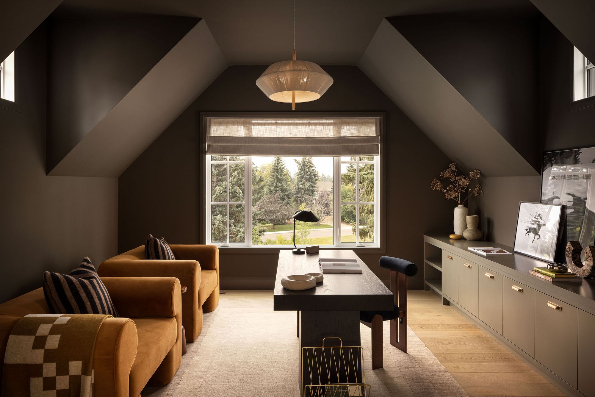 Upstairs office with dark walls and window in The Charlotte home