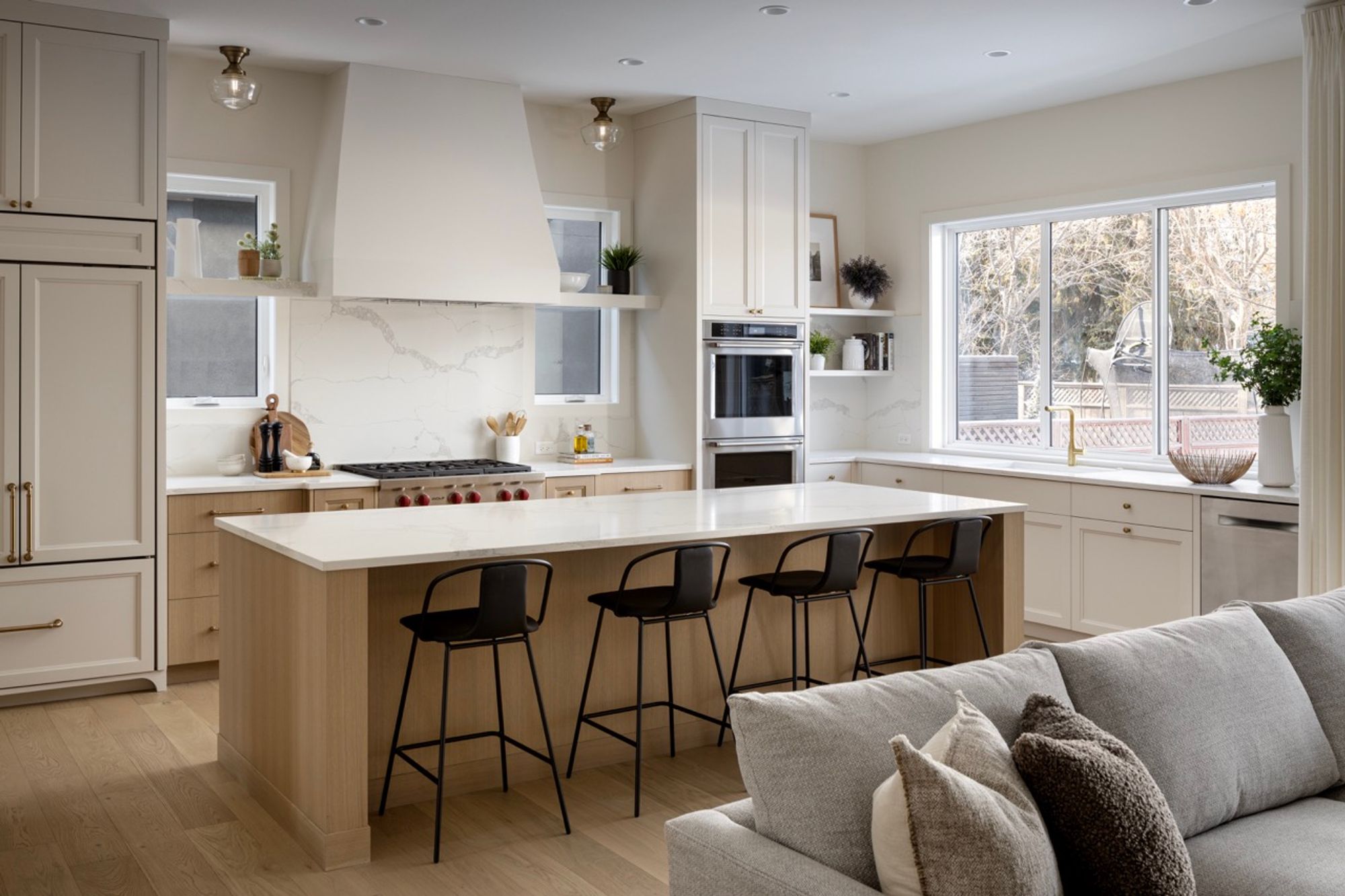 Kitchen with island and black stools in the Riverdale home