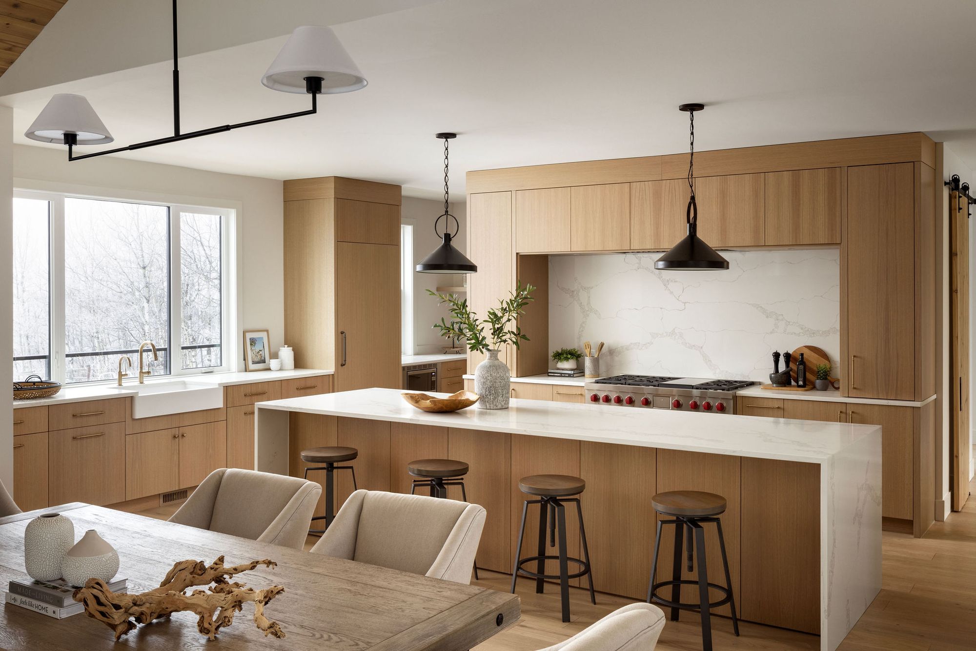 Kitchen and dining area with a wood island in the Priddis home