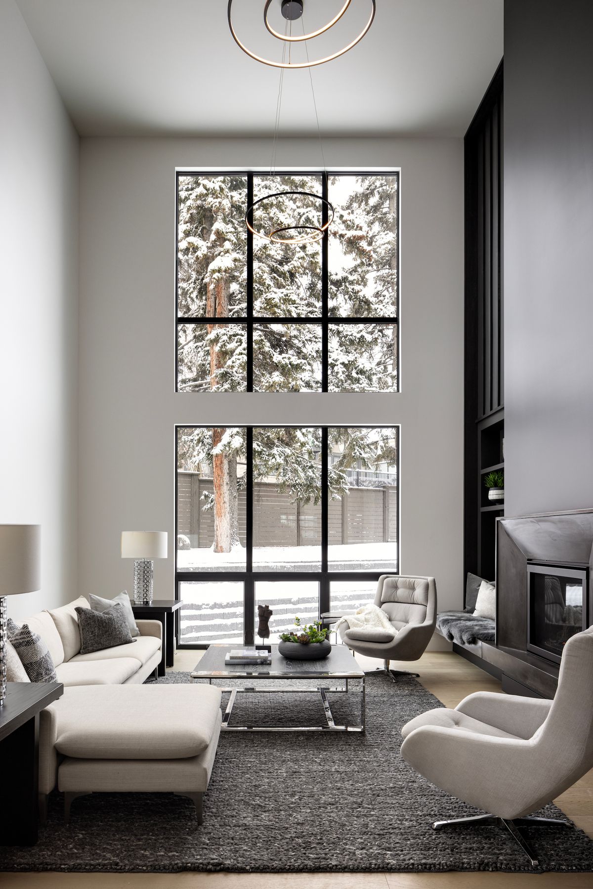 Tall living room windows with snowy trees outside
