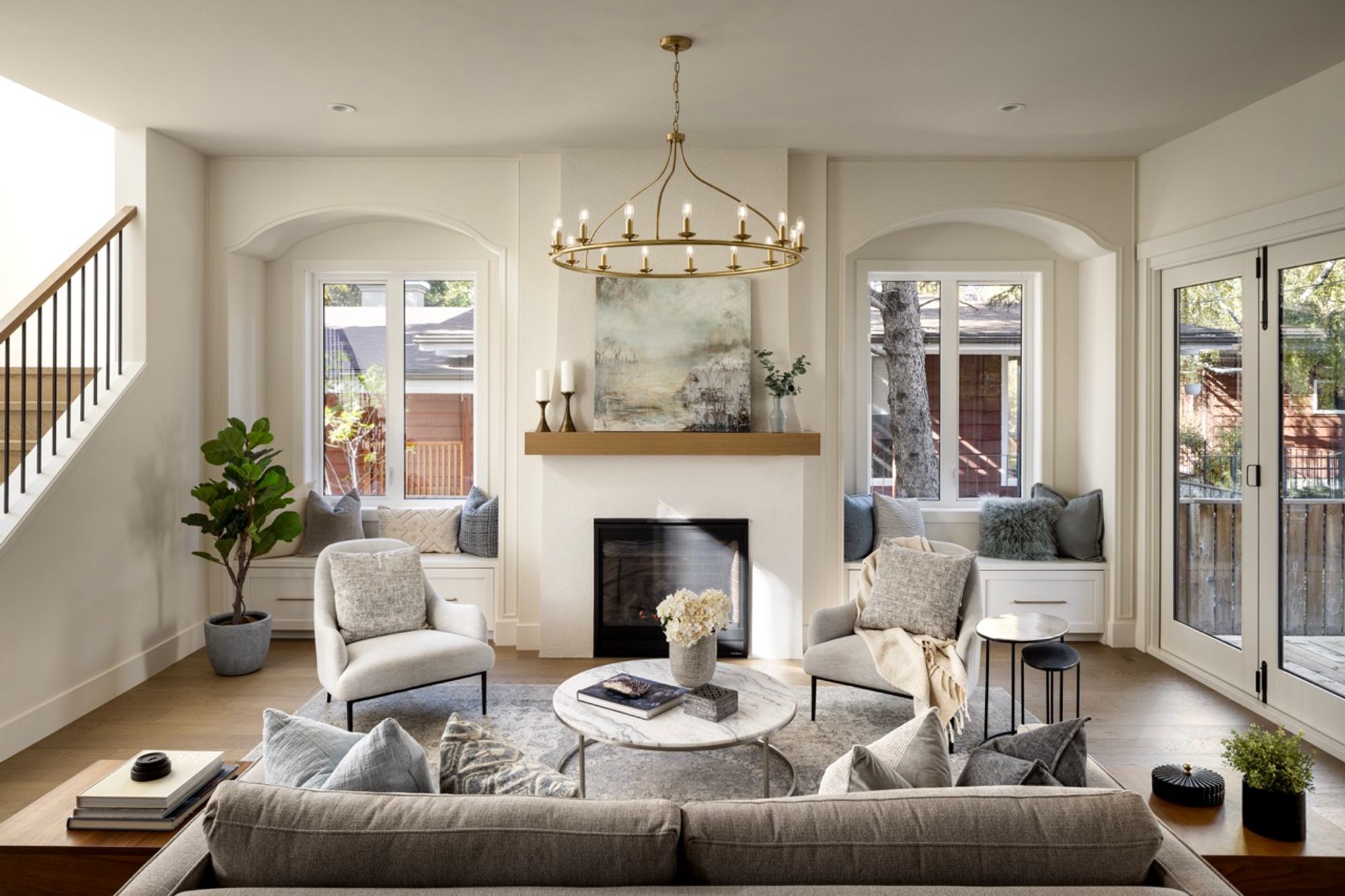 Living room with fireplace and window seats in the Charleswood home