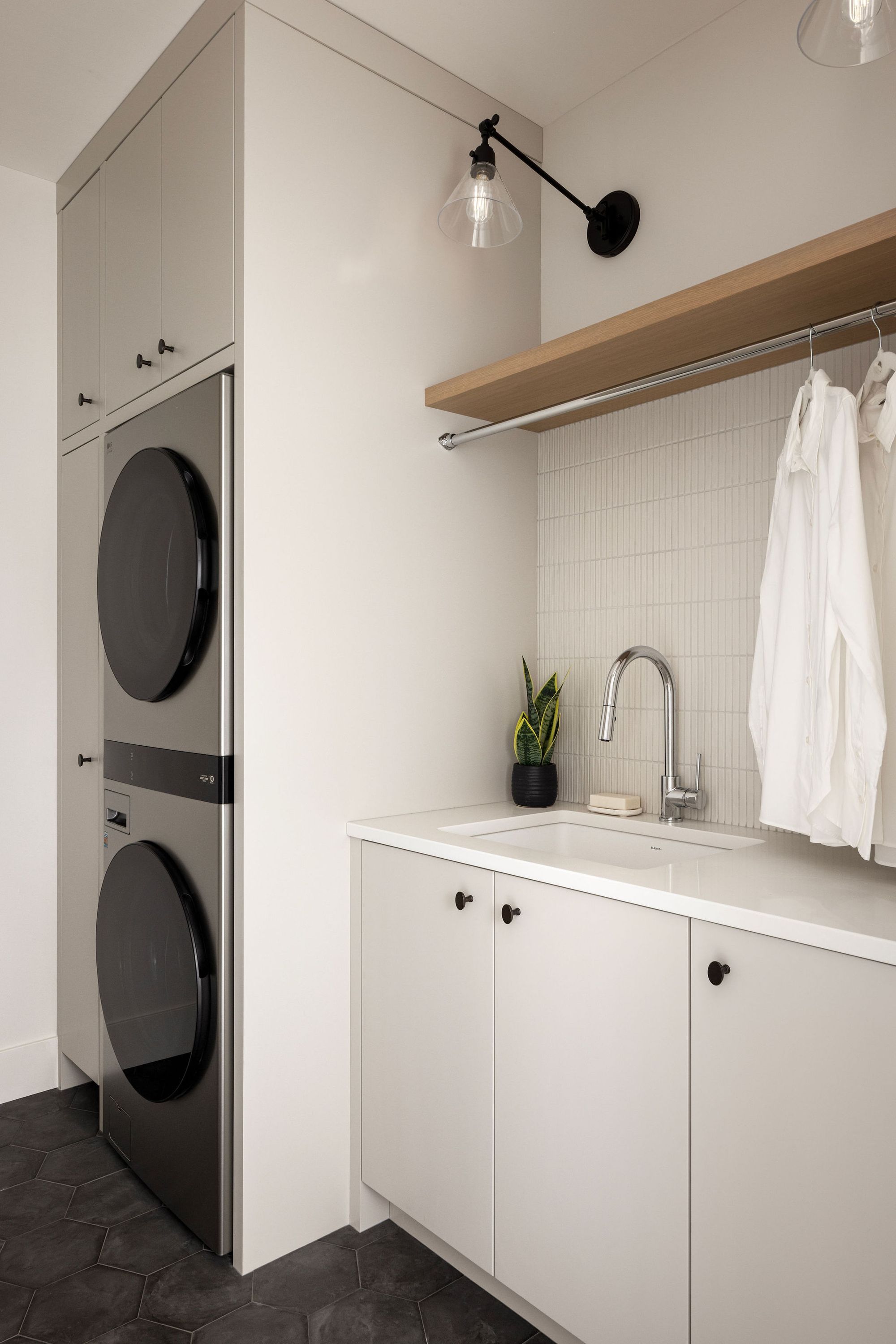 Laundry room with stacked washer and dryer in the Priddis home