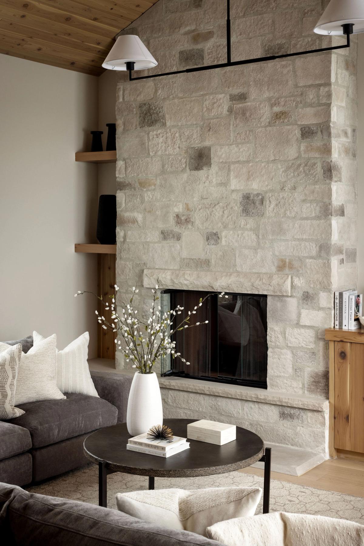 Stone fireplace in the living room of the Priddis home