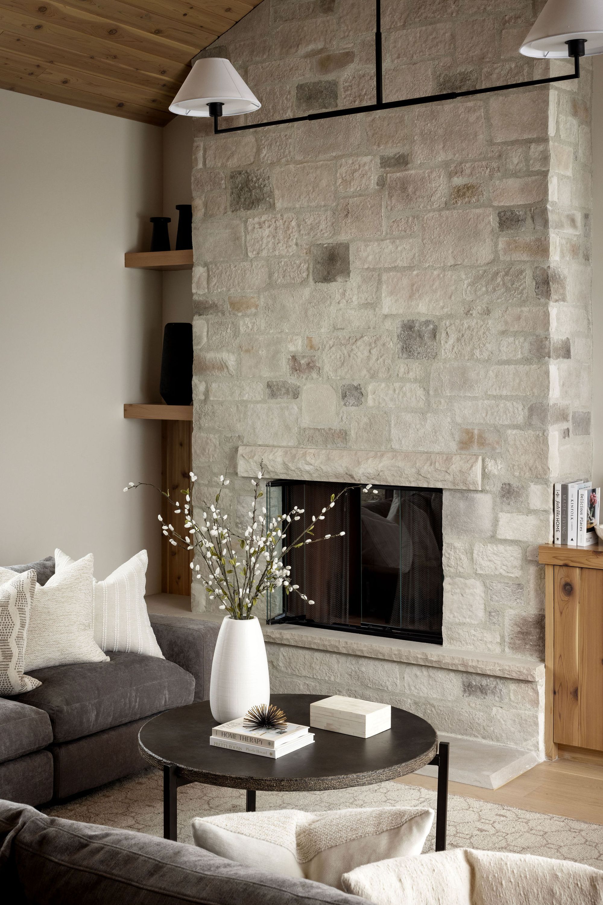 Stone fireplace in the living room of the Priddis home