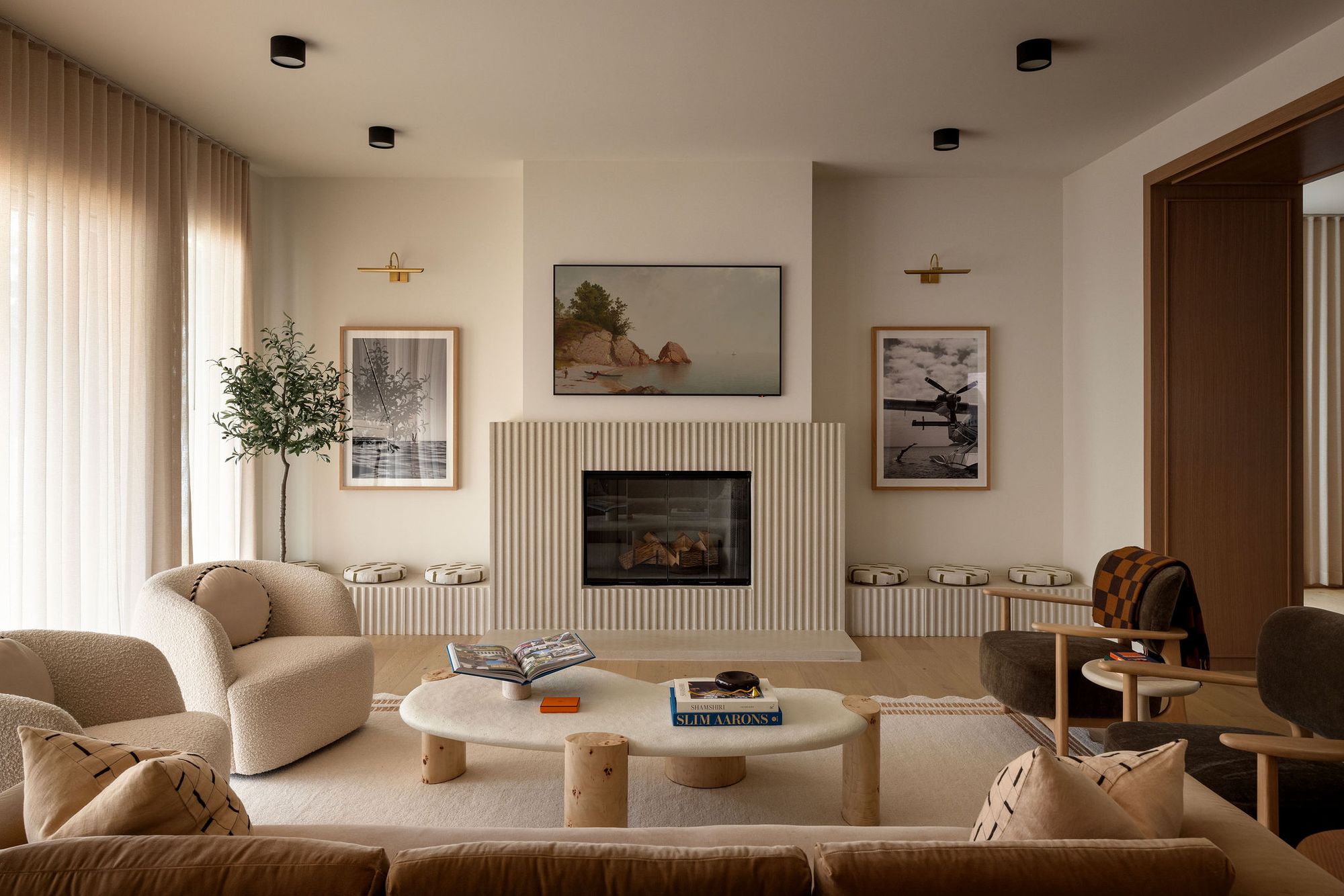 Living room with fluted fireplace and curtains in The Charlotte home