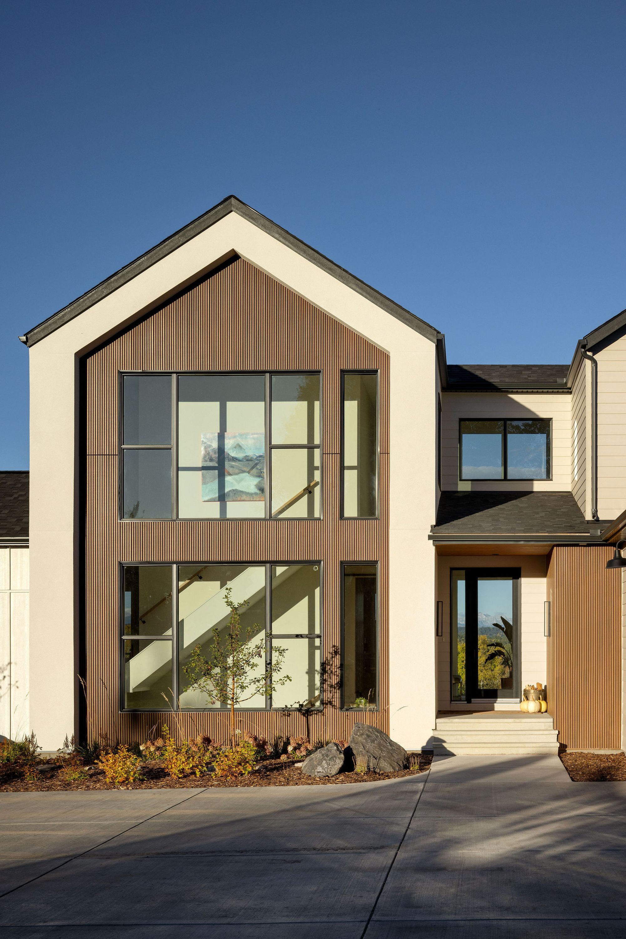 Wood-clad gable and large windows on the Priddis home