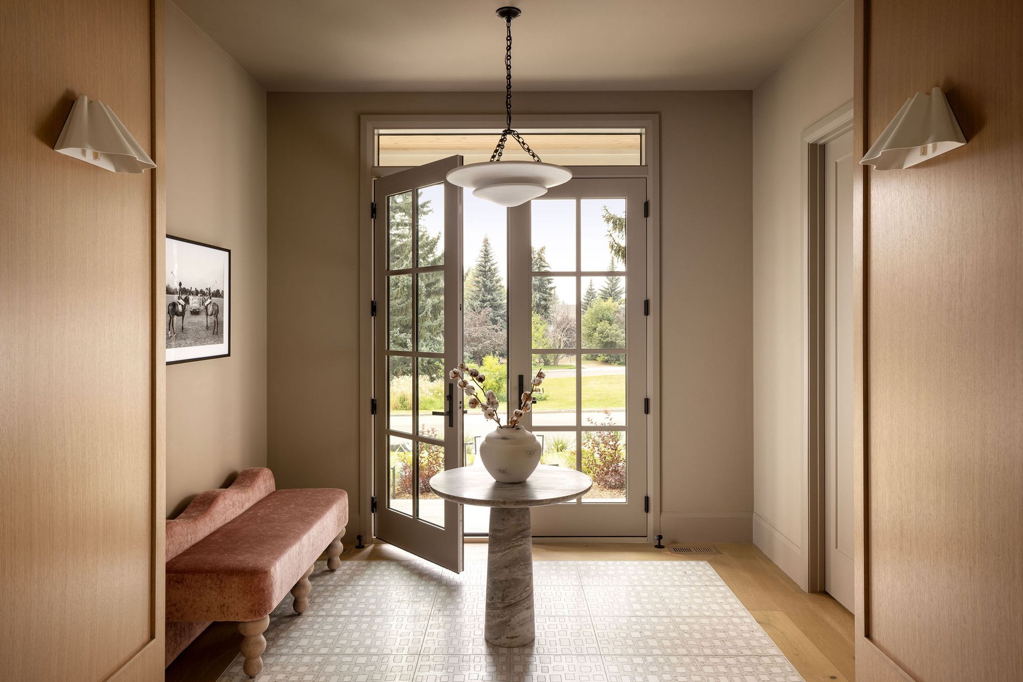 Entry with round table and glass doors in The Charlotte home
