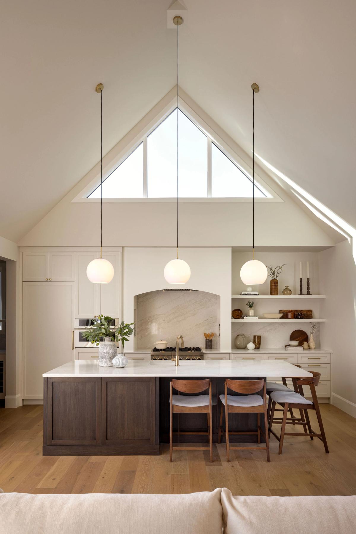 Kitchen with vaulted ceiling and island in the Altadore 2 home