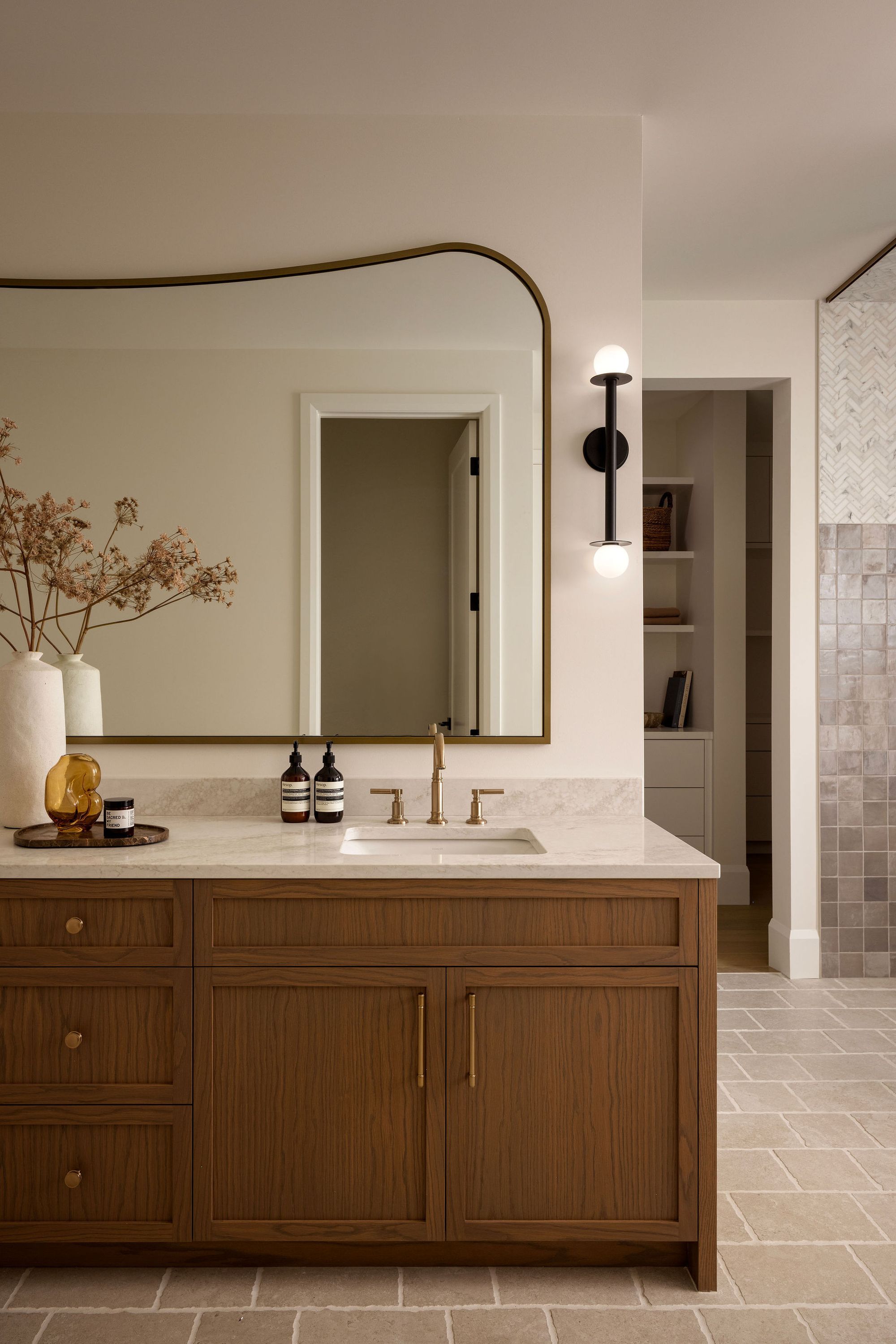 Bathroom vanity with arched mirror in The Charlotte home