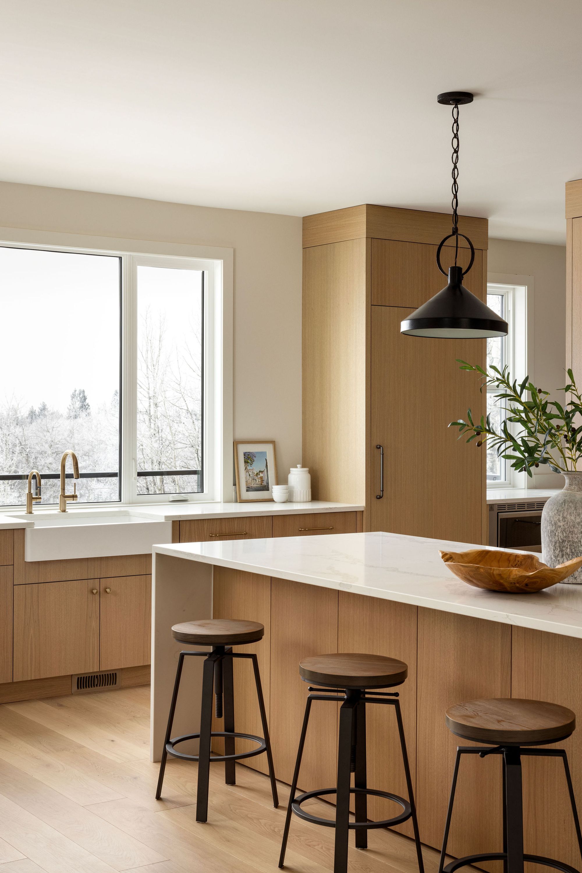 Kitchen island with counter stools in the Priddis home