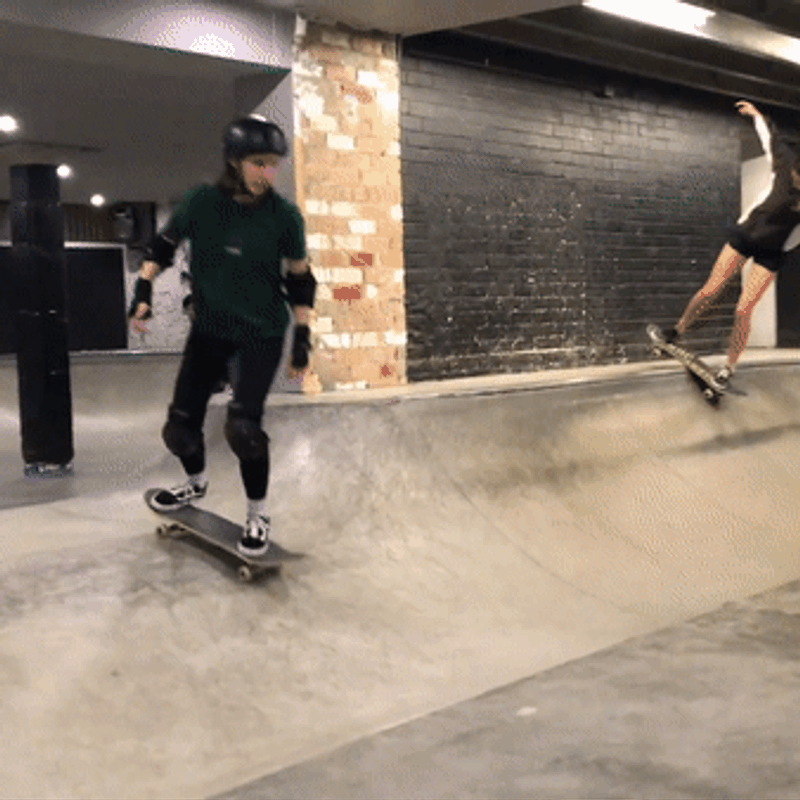 Animated gif of Lauren skateboarding, throwing her hands up in celebration