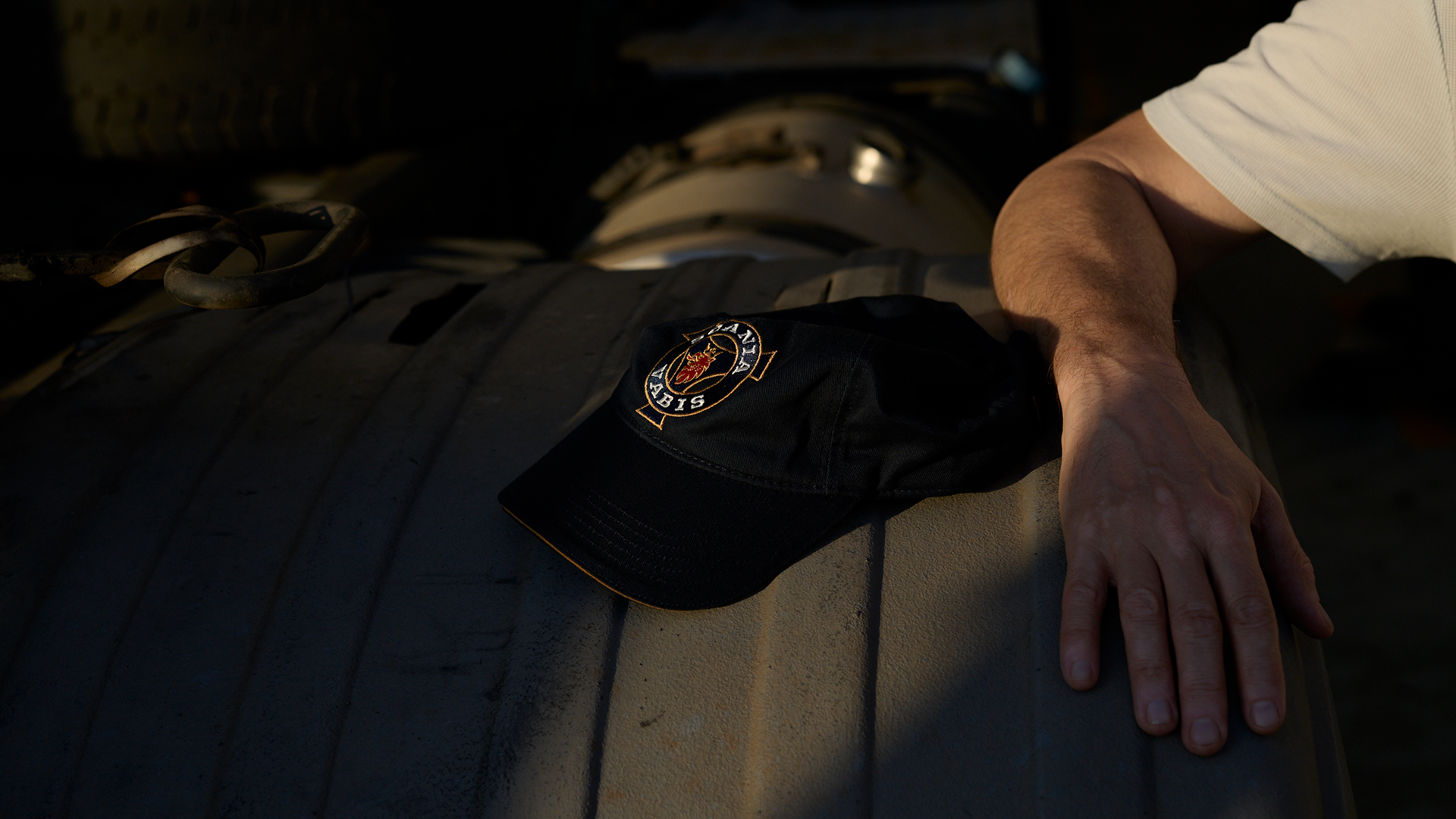 Scania logo on the top of a dark cap.