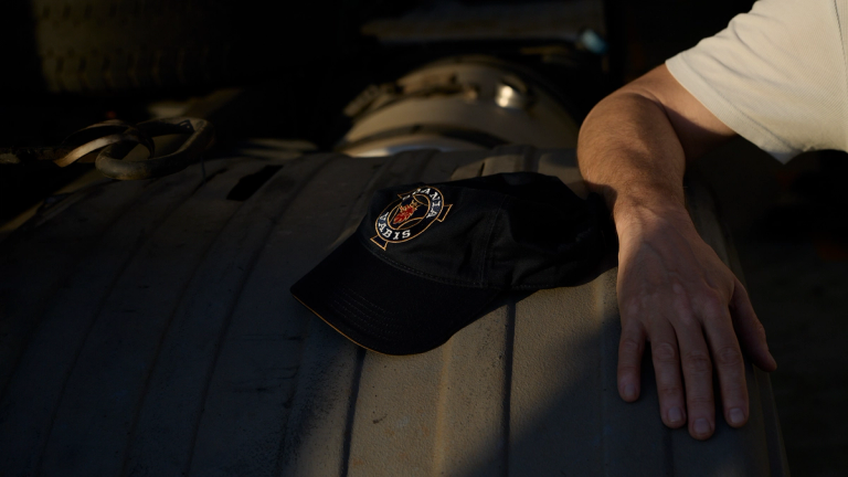 Scania logo on the top of a dark cap.