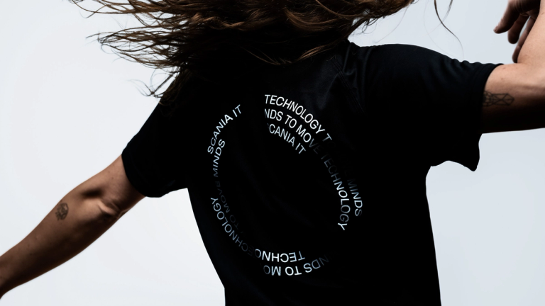 Person in motion wearing a black Scania running t-shirt.