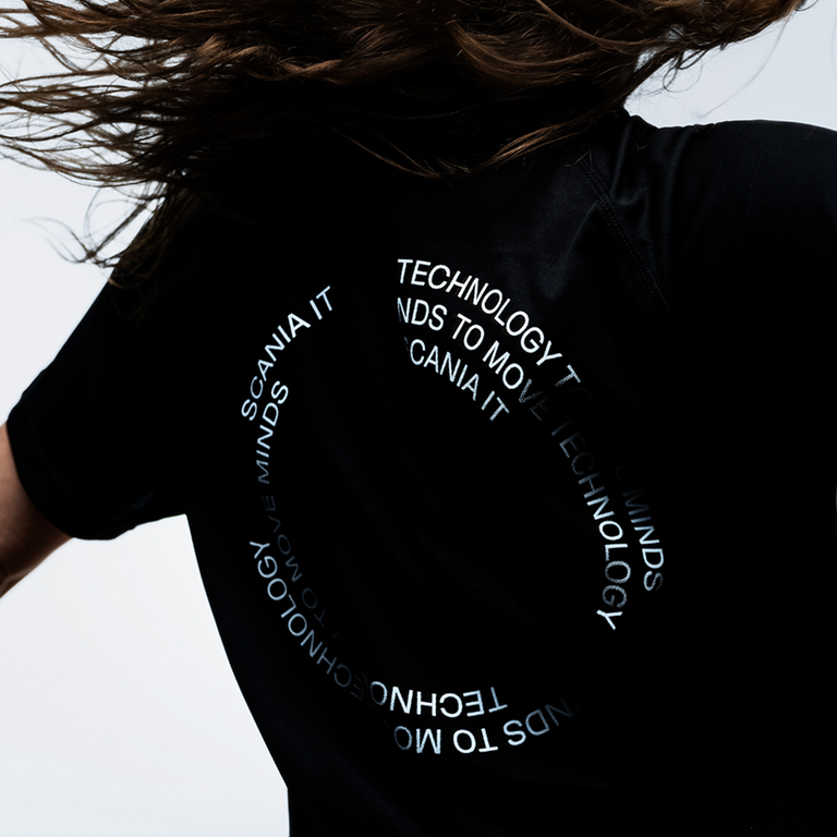 Person in motion wearing a black Scania running t-shirt.
