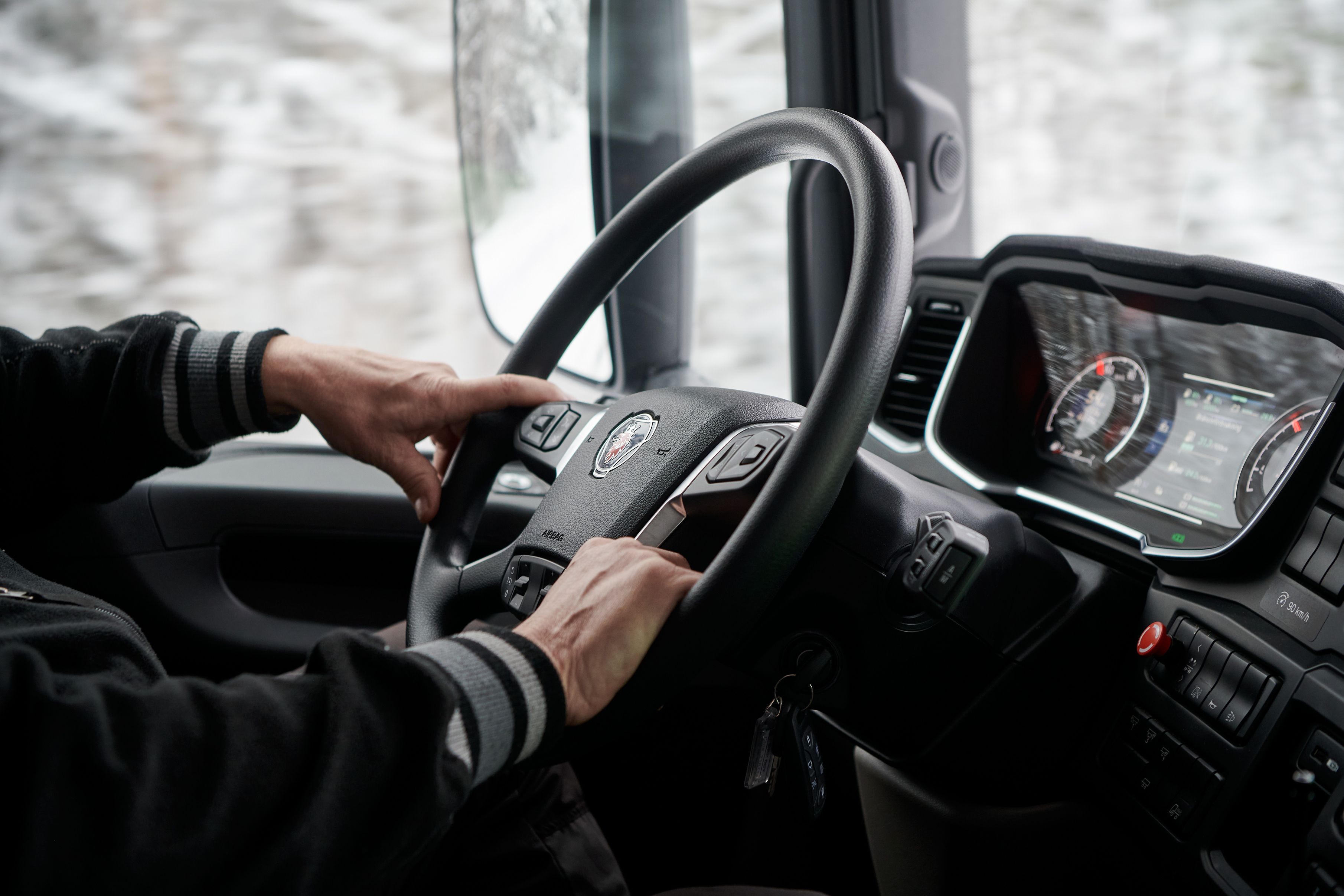 Closeup of driver's hands on a steering wheel