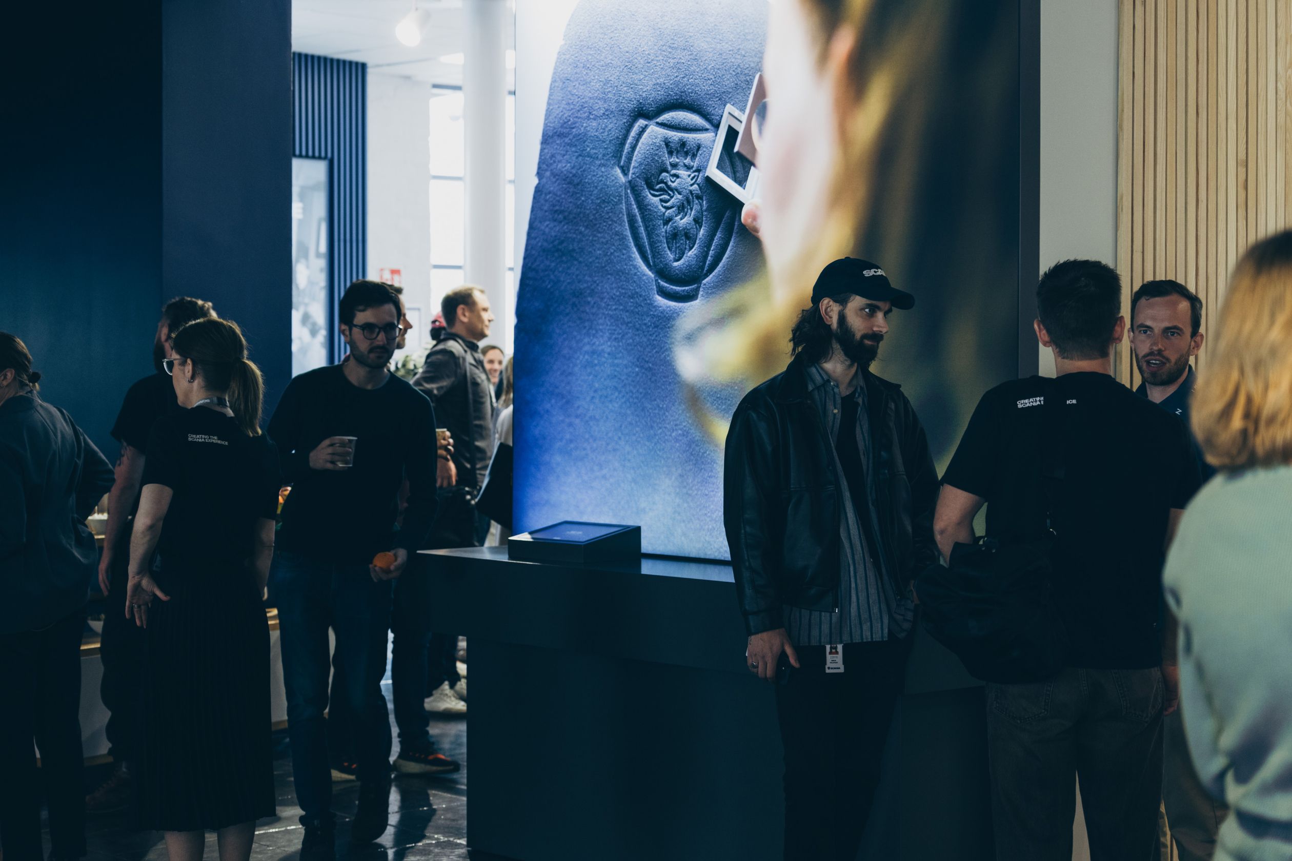 Groups of people chatting during the Scania Experience Meetup