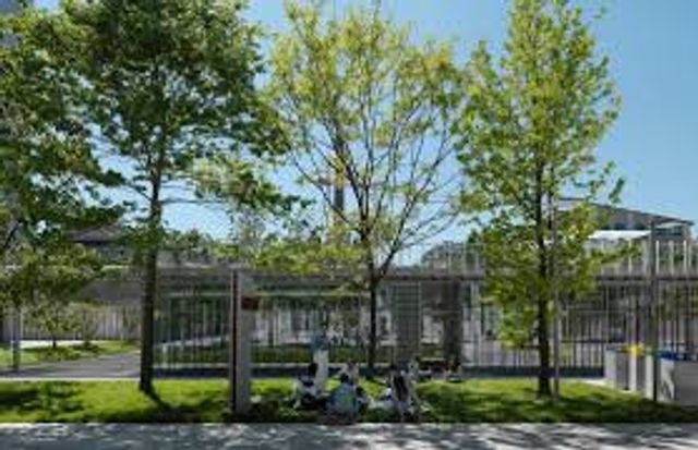 Students outside Politecnico di Milano campus building during IMC visit