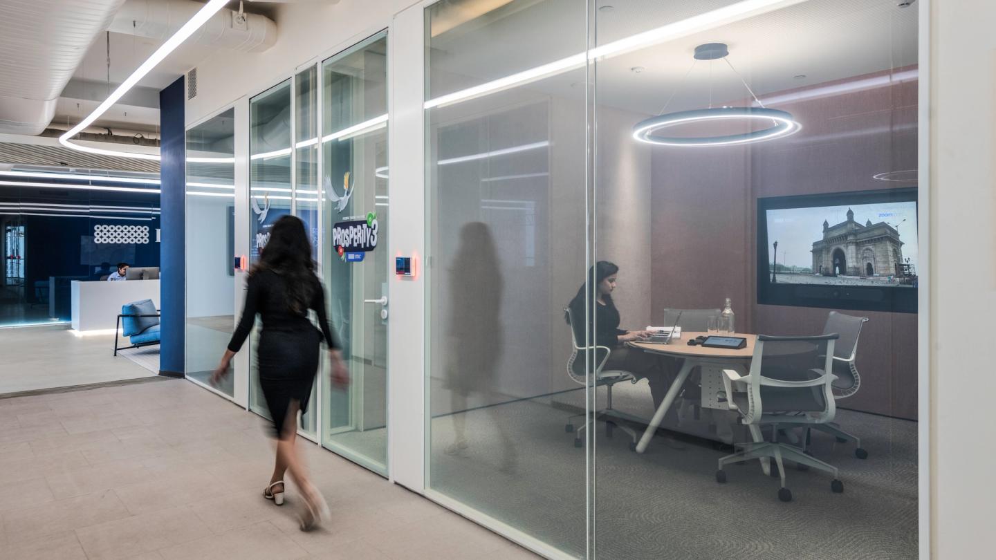 IMC employee in a modern meeting room at the Mumbai office