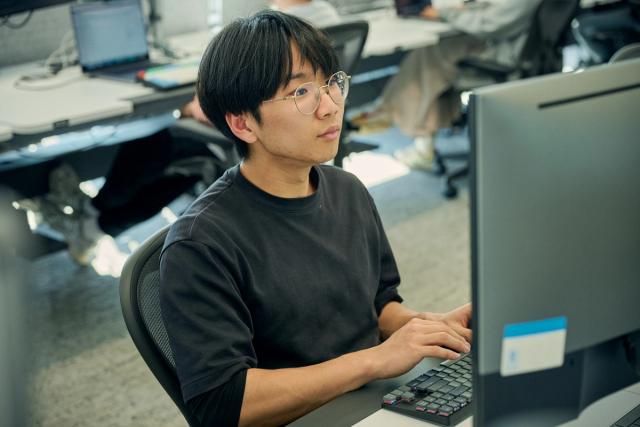 Employee working on a computer at IMC’s Sydney office