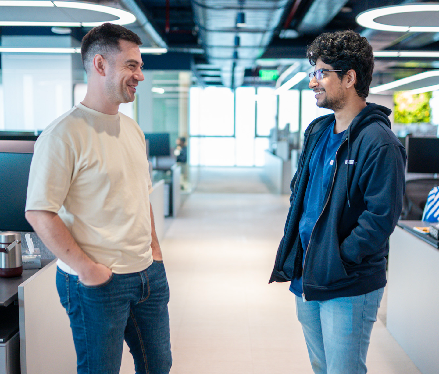 IMC employees having a discussion inside the Mumbai office workspace
