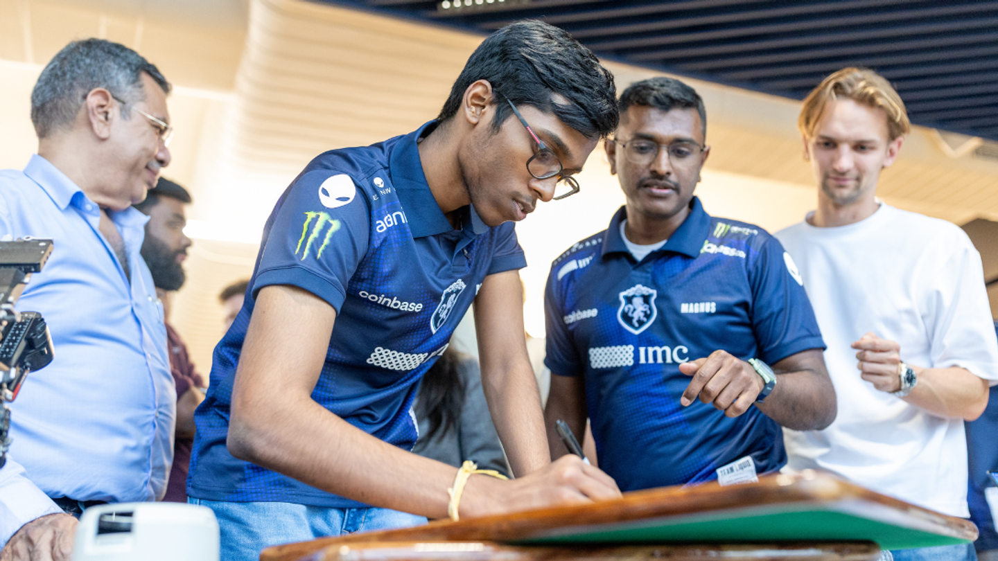 Grandmaster Praggnanandhaa signing autographs during his visit to IMC’s Mumbai office