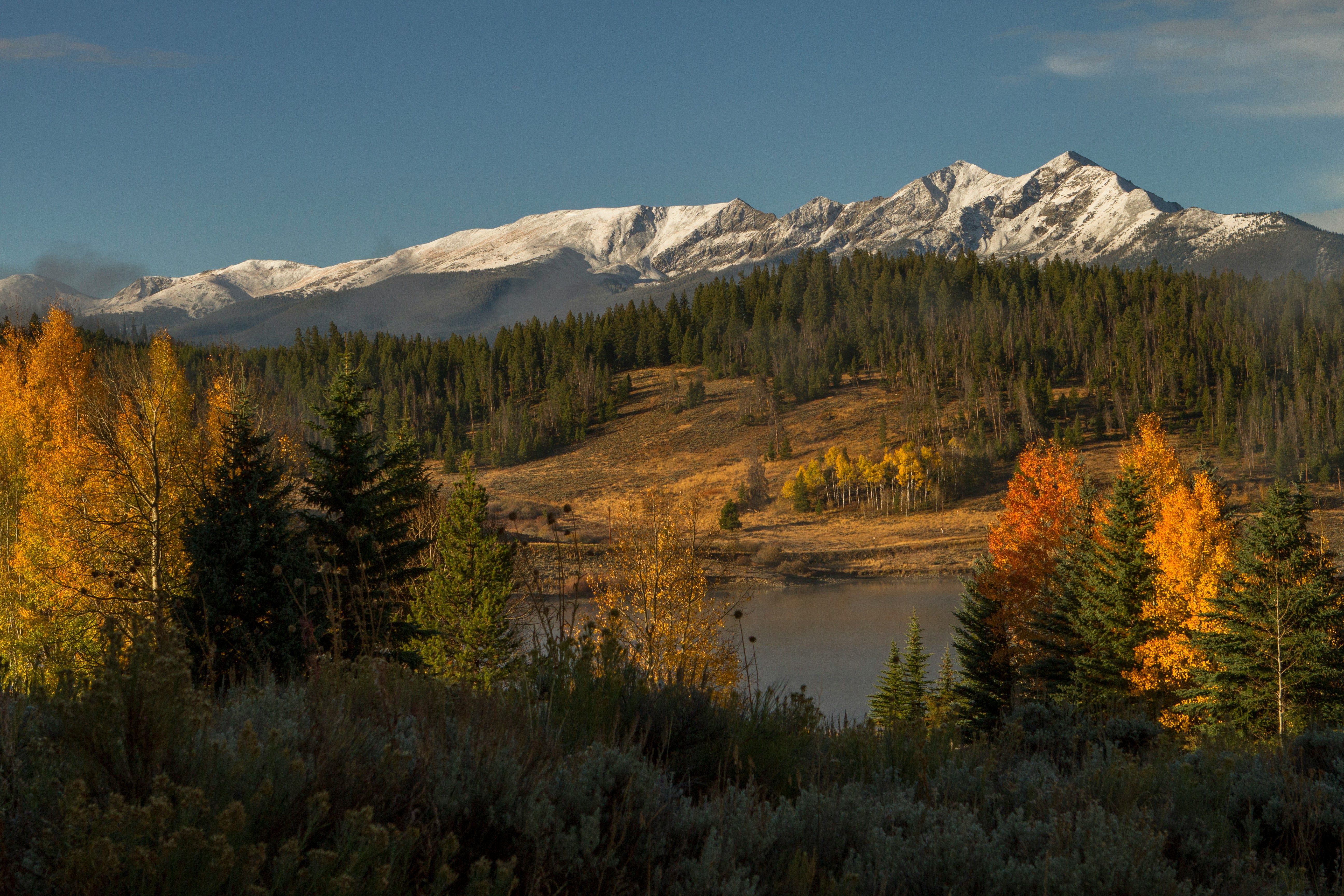 Snow-capped mountains overlook a lake surrounded by green hills and vibrant yellow and orange fall foliage.​​​​‌﻿‍﻿​‍​‍‌‍﻿﻿‌﻿​‍‌‍‍‌‌‍‌﻿‌‍‍‌‌‍﻿‍​‍​‍​﻿‍‍​‍​‍‌﻿​﻿‌‍​‌‌‍﻿‍‌‍‍‌‌﻿‌​‌﻿‍‌​‍﻿‍‌‍‍‌‌‍﻿﻿​‍​‍​‍﻿​​‍​‍‌‍‍​‌﻿​‍‌‍‌‌‌‍‌‍​‍​‍​﻿‍‍​‍​‍​‍﻿﻿‌﻿​﻿‌﻿‌​‌﻿‌‌‌‍‌​‌‍‍‌‌‍﻿﻿​‍﻿﻿‌‍‍‌‌‍﻿‍‌﻿‌​‌‍‌‌‌‍﻿‍‌﻿‌​​‍﻿﻿‌‍‌‌‌‍‌​‌‍‍‌‌﻿‌​​‍﻿﻿‌‍﻿‌‌‍﻿﻿‌‍‌​‌‍‌‌​﻿﻿‌‌﻿​​‌﻿​‍‌‍‌‌‌﻿​﻿‌‍‌‌‌‍﻿‍‌﻿‌​‌‍​‌‌﻿‌​‌‍‍‌‌‍﻿﻿‌‍﻿‍​﻿‍﻿‌‍‍‌‌‍‌​​﻿﻿‌​﻿​‌​﻿​‍‌‍‌‌​﻿​﻿​﻿​‍‌‍​‌‌‍​‌​﻿‍​​‍﻿‌‌‍​‍​﻿‌﻿‌‍​﻿​﻿‍​​‍﻿‌​﻿‌​‌‍​‌​﻿‌﻿​﻿‌‍​‍﻿‌‌‍​‍‌‍​﻿​﻿‌‍​﻿‍​​‍﻿‌​﻿​​​﻿‍​‌‍‌‌‌‍‌‍‌‍‌‌​﻿‍​‌‍​‍​﻿‍​‌‍​‌​﻿‍‌​﻿‍‌​﻿​﻿​﻿‍﻿‌﻿‌​‌﻿‍‌‌﻿​​‌‍‌‌​﻿﻿‌‌﻿​​‌‍﻿﻿‌﻿​﻿‌﻿‌​​﻿‍﻿‌﻿​​‌‍​‌‌﻿‌​‌‍‍​​﻿﻿‌‌‍​﻿‌‍﻿﻿‌﻿‌‍‌‍‌‌‌﻿​‍‌​‍‌‌‍﻿‌‌‍​‌‌‍‌﻿‌‍‌‌​‍﻿‍‌‍​‌‌‍﻿​‌﻿‌​​﻿﻿﻿‌‍​‍‌‍​‌‌﻿​﻿‌‍‌‌‌‌‌‌‌﻿​‍‌‍﻿​​﻿﻿‌​‍‌‌​﻿​‍‌​‌‍‌﻿​﻿‌﻿‌​‌﻿‌‌‌‍‌​‌‍‍‌‌‍﻿﻿​‍‌‍‌‍‍‌‌‍‌​​﻿﻿‌​﻿​‌​﻿​‍‌‍‌‌​﻿​﻿​﻿​‍‌‍​‌‌‍​‌​﻿‍​​‍﻿‌‌‍​‍​﻿‌﻿‌‍​﻿​﻿‍​​‍﻿‌​﻿‌​‌‍​‌​﻿‌﻿​﻿‌‍​‍﻿‌‌‍​‍‌‍​﻿​﻿‌‍​﻿‍​​‍﻿‌​﻿​​​﻿‍​‌‍‌‌‌‍‌‍‌‍‌‌​﻿‍​‌‍​‍​﻿‍​‌‍​‌​﻿‍‌​﻿‍‌​﻿​﻿​‍‌‍‌﻿‌​‌﻿‍‌‌﻿​​‌‍‌‌​﻿﻿‌‌﻿​​‌‍﻿﻿‌﻿​﻿‌﻿‌​​‍‌‍‌﻿​​‌‍​‌‌﻿‌​‌‍‍​​﻿﻿‌‌‍​﻿‌‍﻿﻿‌﻿‌‍‌‍‌‌‌﻿​‍‌​‍‌‌‍﻿‌‌‍​‌‌‍‌﻿‌‍‌‌​‍﻿‍‌‍​‌‌‍﻿​‌﻿‌​​‍‌‍‌﻿​​‌‍‌‌‌﻿​‍‌﻿​﻿‌﻿​​‌‍‌‌‌‍​﻿‌﻿‌​‌‍‍‌‌﻿‌‍‌‍‌‌​﻿﻿‌‌﻿​​‌﻿‌‌‌‍​‍‌‍﻿​‌‍‍‌‌﻿​﻿‌‍‍​‌‍‌‌‌‍‌​​‍​‍‌﻿﻿‌
