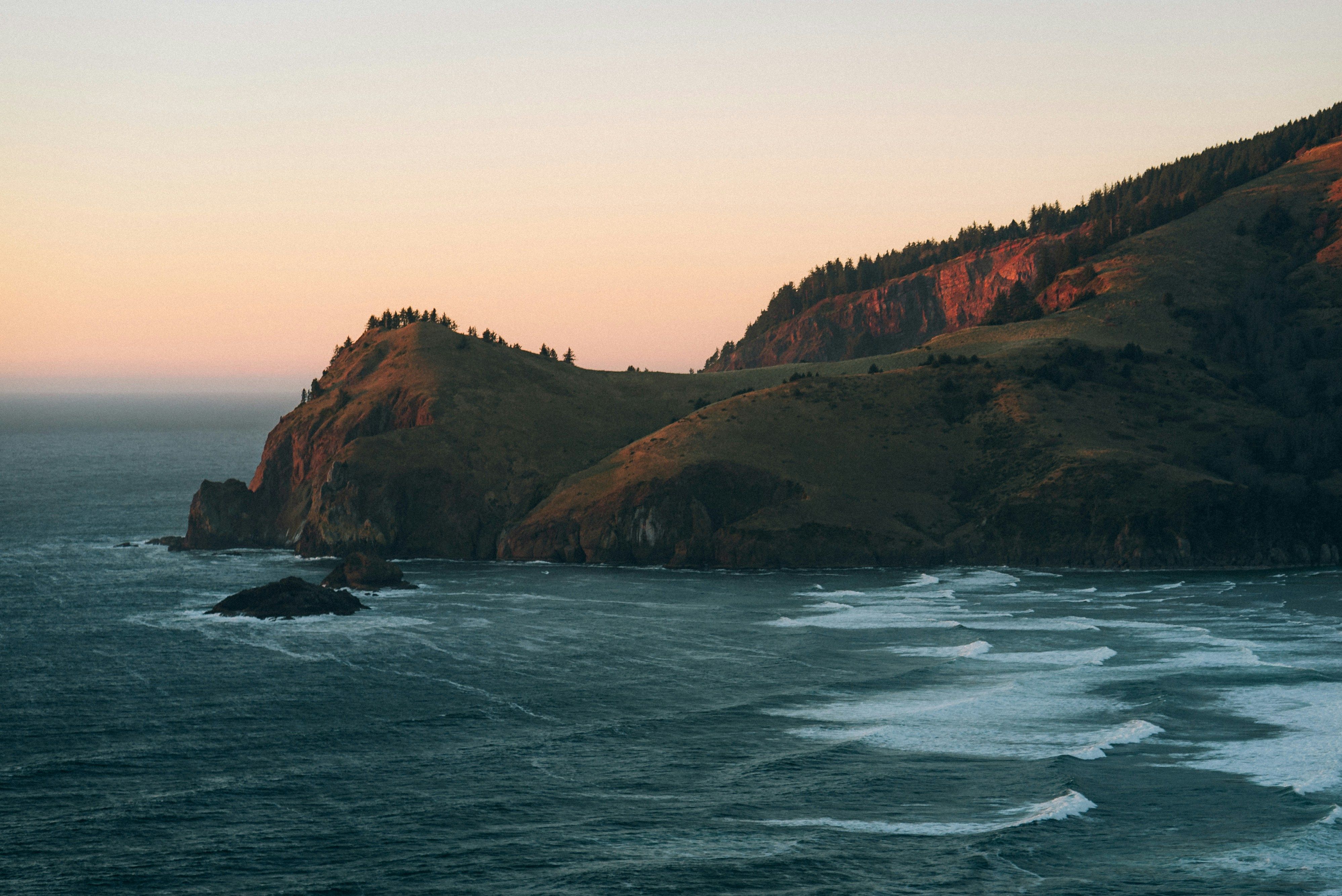 Golden sunset light bathes forested coastal hills above an ocean with white-capped waves.​​​​‌﻿‍﻿​‍​‍‌‍﻿﻿‌﻿​‍‌‍‍‌‌‍‌﻿‌‍‍‌‌‍﻿‍​‍​‍​﻿‍‍​‍​‍‌﻿​﻿‌‍​‌‌‍﻿‍‌‍‍‌‌﻿‌​‌﻿‍‌​‍﻿‍‌‍‍‌‌‍﻿﻿​‍​‍​‍﻿​​‍​‍‌‍‍​‌﻿​‍‌‍‌‌‌‍‌‍​‍​‍​﻿‍‍​‍​‍​‍﻿﻿‌﻿​﻿‌﻿‌​‌﻿‌‌‌‍‌​‌‍‍‌‌‍﻿﻿​‍﻿﻿‌‍‍‌‌‍﻿‍‌﻿‌​‌‍‌‌‌‍﻿‍‌﻿‌​​‍﻿﻿‌‍‌‌‌‍‌​‌‍‍‌‌﻿‌​​‍﻿﻿‌‍﻿‌‌‍﻿﻿‌‍‌​‌‍‌‌​﻿﻿‌‌﻿​​‌﻿​‍‌‍‌‌‌﻿​﻿‌‍‌‌‌‍﻿‍‌﻿‌​‌‍​‌‌﻿‌​‌‍‍‌‌‍﻿﻿‌‍﻿‍​﻿‍﻿‌‍‍‌‌‍‌​​﻿﻿‌​﻿‌‍​﻿​​‌‍​‍​﻿‌​​﻿​​​﻿‌‌‌‍​‌​﻿‍​​‍﻿‌‌‍‌‌​﻿‌​‌‍‌​‌‍​‌​‍﻿‌​﻿‌​​﻿‍‌​﻿‍‌​﻿​‌​‍﻿‌‌‍​‍​﻿​﻿​﻿​‍‌‍​‌​‍﻿‌‌‍‌‌​﻿‌‍​﻿​​​﻿‍​​﻿‍​​﻿​​​﻿‌​​﻿‌﻿​﻿‌‌​﻿​​​﻿​‍​﻿​​​﻿‍﻿‌﻿‌​‌﻿‍‌‌﻿​​‌‍‌‌​﻿﻿‌‌﻿​​‌‍﻿﻿‌﻿​﻿‌﻿‌​​﻿‍﻿‌﻿​​‌‍​‌‌﻿‌​‌‍‍​​﻿﻿‌‌‍​﻿‌‍﻿﻿‌﻿‌‍‌‍‌‌‌﻿​‍‌​‍‌‌‍﻿‌‌‍​‌‌‍‌﻿‌‍‌‌​‍﻿‍‌‍​‌‌‍﻿​‌﻿‌​​﻿﻿﻿‌‍​‍‌‍​‌‌﻿​﻿‌‍‌‌‌‌‌‌‌﻿​‍‌‍﻿​​﻿﻿‌​‍‌‌​﻿​‍‌​‌‍‌﻿​﻿‌﻿‌​‌﻿‌‌‌‍‌​‌‍‍‌‌‍﻿﻿​‍‌‍‌‍‍‌‌‍‌​​﻿﻿‌​﻿‌‍​﻿​​‌‍​‍​﻿‌​​﻿​​​﻿‌‌‌‍​‌​﻿‍​​‍﻿‌‌‍‌‌​﻿‌​‌‍‌​‌‍​‌​‍﻿‌​﻿‌​​﻿‍‌​﻿‍‌​﻿​‌​‍﻿‌‌‍​‍​﻿​﻿​﻿​‍‌‍​‌​‍﻿‌‌‍‌‌​﻿‌‍​﻿​​​﻿‍​​﻿‍​​﻿​​​﻿‌​​﻿‌﻿​﻿‌‌​﻿​​​﻿​‍​﻿​​​‍‌‍‌﻿‌​‌﻿‍‌‌﻿​​‌‍‌‌​﻿﻿‌‌﻿​​‌‍﻿﻿‌﻿​﻿‌﻿‌​​‍‌‍‌﻿​​‌‍​‌‌﻿‌​‌‍‍​​﻿﻿‌‌‍​﻿‌‍﻿﻿‌﻿‌‍‌‍‌‌‌﻿​‍‌​‍‌‌‍﻿‌‌‍​‌‌‍‌﻿‌‍‌‌​‍﻿‍‌‍​‌‌‍﻿​‌﻿‌​​‍‌‍‌﻿​​‌‍‌‌‌﻿​‍‌﻿​﻿‌﻿​​‌‍‌‌‌‍​﻿‌﻿‌​‌‍‍‌‌﻿‌‍‌‍‌‌​﻿﻿‌‌﻿​​‌﻿‌‌‌‍​‍‌‍﻿​‌‍‍‌‌﻿​﻿‌‍‍​‌‍‌‌‌‍‌​​‍​‍‌﻿﻿‌