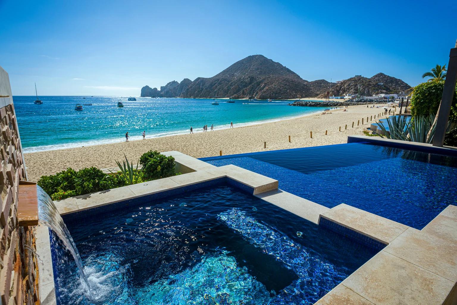 An infinity pool and hot tub overlook a vibrant beach with turquoise water, mountains, and boats.​​​​‌﻿‍﻿​‍​‍‌‍﻿﻿‌﻿​‍‌‍‍‌‌‍‌﻿‌‍‍‌‌‍﻿‍​‍​‍​﻿‍‍​‍​‍‌﻿​﻿‌‍​‌‌‍﻿‍‌‍‍‌‌﻿‌​‌﻿‍‌​‍﻿‍‌‍‍‌‌‍﻿﻿​‍​‍​‍﻿​​‍​‍‌‍‍​‌﻿​‍‌‍‌‌‌‍‌‍​‍​‍​﻿‍‍​‍​‍​‍﻿﻿‌﻿​﻿‌﻿‌​‌﻿‌‌‌‍‌​‌‍‍‌‌‍﻿﻿​‍﻿﻿‌‍‍‌‌‍﻿‍‌﻿‌​‌‍‌‌‌‍﻿‍‌﻿‌​​‍﻿﻿‌‍‌‌‌‍‌​‌‍‍‌‌﻿‌​​‍﻿﻿‌‍﻿‌‌‍﻿﻿‌‍‌​‌‍‌‌​﻿﻿‌‌﻿​​‌﻿​‍‌‍‌‌‌﻿​﻿‌‍‌‌‌‍﻿‍‌﻿‌​‌‍​‌‌﻿‌​‌‍‍‌‌‍﻿﻿‌‍﻿‍​﻿‍﻿‌‍‍‌‌‍‌​​﻿﻿‌​﻿‍‌​﻿‌﻿‌‍‌​​﻿​​​﻿​‍​﻿​‌​﻿‍‌​﻿‍​​‍﻿‌​﻿​​​﻿​​​﻿‌‍‌‍‌‍​‍﻿‌​﻿‌​​﻿​‌‌‍‌‍​﻿​‌​‍﻿‌‌‍​‍‌‍​﻿​﻿‍​​﻿‌​​‍﻿‌​﻿​‌​﻿‍​‌‍​‌​﻿‌﻿​﻿‍‌​﻿‌‍​﻿‌​​﻿‌‍​﻿‌‌‌‍​‌​﻿‌​​﻿‍‌​﻿‍﻿‌﻿‌​‌﻿‍‌‌﻿​​‌‍‌‌​﻿﻿‌‌﻿​​‌‍﻿﻿‌﻿​﻿‌﻿‌​​﻿‍﻿‌﻿​​‌‍​‌‌﻿‌​‌‍‍​​﻿﻿‌‌‍​﻿‌‍﻿﻿‌﻿‌‍‌‍‌‌‌﻿​‍‌​‍‌‌‍﻿‌‌‍​‌‌‍‌﻿‌‍‌‌​‍﻿‍‌‍​‌‌‍﻿​‌﻿‌​​﻿﻿﻿‌‍​‍‌‍​‌‌﻿​﻿‌‍‌‌‌‌‌‌‌﻿​‍‌‍﻿​​﻿﻿‌​‍‌‌​﻿​‍‌​‌‍‌﻿​﻿‌﻿‌​‌﻿‌‌‌‍‌​‌‍‍‌‌‍﻿﻿​‍‌‍‌‍‍‌‌‍‌​​﻿﻿‌​﻿‍‌​﻿‌﻿‌‍‌​​﻿​​​﻿​‍​﻿​‌​﻿‍‌​﻿‍​​‍﻿‌​﻿​​​﻿​​​﻿‌‍‌‍‌‍​‍﻿‌​﻿‌​​﻿​‌‌‍‌‍​﻿​‌​‍﻿‌‌‍​‍‌‍​﻿​﻿‍​​﻿‌​​‍﻿‌​﻿​‌​﻿‍​‌‍​‌​﻿‌﻿​﻿‍‌​﻿‌‍​﻿‌​​﻿‌‍​﻿‌‌‌‍​‌​﻿‌​​﻿‍‌​‍‌‍‌﻿‌​‌﻿‍‌‌﻿​​‌‍‌‌​﻿﻿‌‌﻿​​‌‍﻿﻿‌﻿​﻿‌﻿‌​​‍‌‍‌﻿​​‌‍​‌‌﻿‌​‌‍‍​​﻿﻿‌‌‍​﻿‌‍﻿﻿‌﻿‌‍‌‍‌‌‌﻿​‍‌​‍‌‌‍﻿‌‌‍​‌‌‍‌﻿‌‍‌‌​‍﻿‍‌‍​‌‌‍﻿​‌﻿‌​​‍‌‍‌﻿​​‌‍‌‌‌﻿​‍‌﻿​﻿‌﻿​​‌‍‌‌‌‍​﻿‌﻿‌​‌‍‍‌‌﻿‌‍‌‍‌‌​﻿﻿‌‌﻿​​‌﻿‌‌‌‍​‍‌‍﻿​‌‍‍‌‌﻿​﻿‌‍‍​‌‍‌‌‌‍‌​​‍​‍‌﻿﻿‌