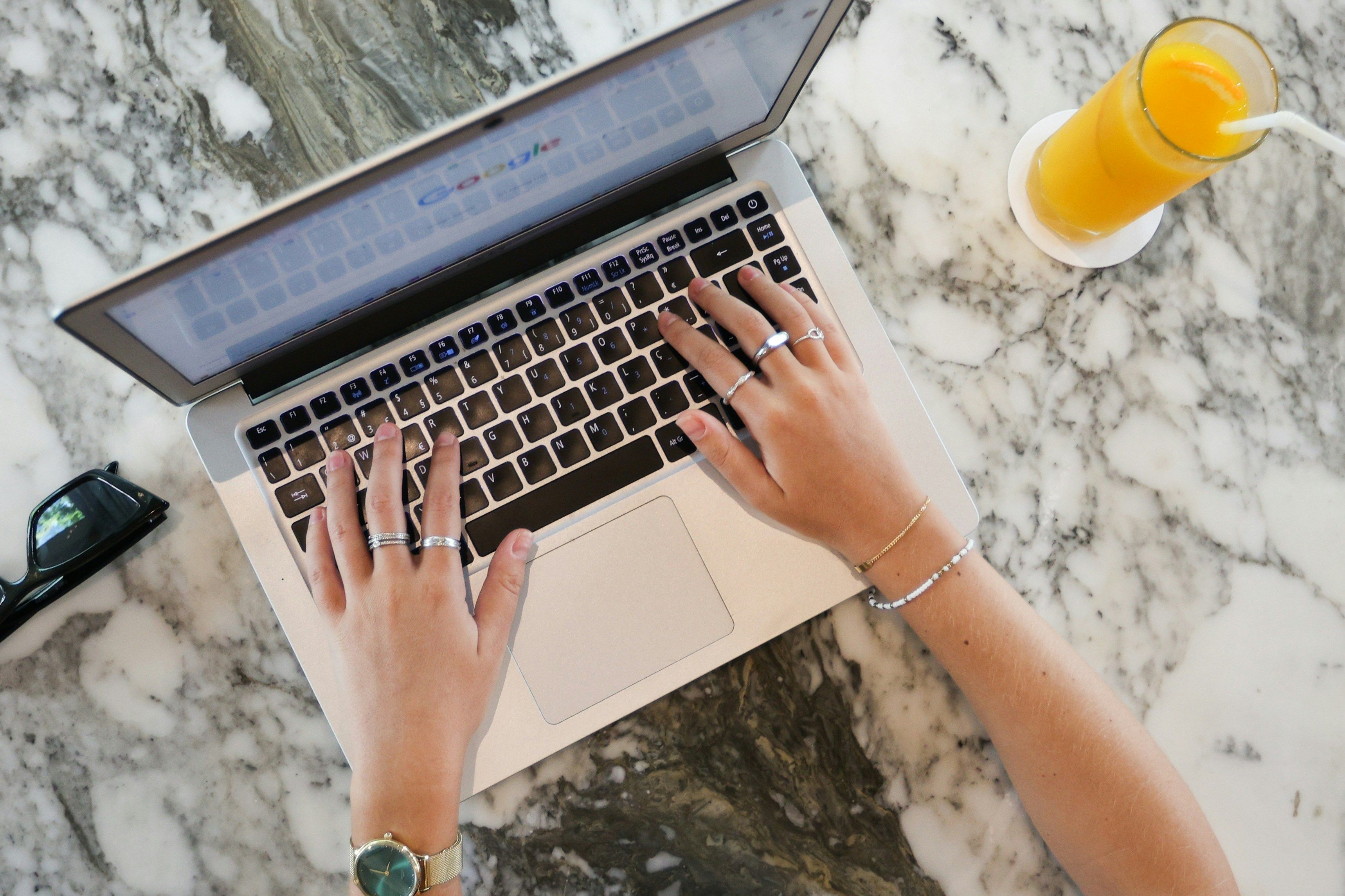 Overhead view of hands typing on a laptop, with orange juice and sunglasses on a marble table.​​​​‌﻿‍﻿​‍​‍‌‍﻿﻿‌﻿​‍‌‍‍‌‌‍‌﻿‌‍‍‌‌‍﻿‍​‍​‍​﻿‍‍​‍​‍‌﻿​﻿‌‍​‌‌‍﻿‍‌‍‍‌‌﻿‌​‌﻿‍‌​‍﻿‍‌‍‍‌‌‍﻿﻿​‍​‍​‍﻿​​‍​‍‌‍‍​‌﻿​‍‌‍‌‌‌‍‌‍​‍​‍​﻿‍‍​‍​‍​‍﻿﻿‌﻿​﻿‌﻿‌​‌﻿‌‌‌‍‌​‌‍‍‌‌‍﻿﻿​‍﻿﻿‌‍‍‌‌‍﻿‍‌﻿‌​‌‍‌‌‌‍﻿‍‌﻿‌​​‍﻿﻿‌‍‌‌‌‍‌​‌‍‍‌‌﻿‌​​‍﻿﻿‌‍﻿‌‌‍﻿﻿‌‍‌​‌‍‌‌​﻿﻿‌‌﻿​​‌﻿​‍‌‍‌‌‌﻿​﻿‌‍‌‌‌‍﻿‍‌﻿‌​‌‍​‌‌﻿‌​‌‍‍‌‌‍﻿﻿‌‍﻿‍​﻿‍﻿‌‍‍‌‌‍‌​​﻿﻿‌​﻿‍​​﻿‌‍​﻿​‌‌‍​‍‌‍‌​‌‍‌‍​﻿‌‍​﻿‌​​‍﻿‌​﻿‌﻿​﻿‍​​﻿‌​​﻿‌‍​‍﻿‌​﻿‌​​﻿​‌​﻿​​‌‍​‍​‍﻿‌​﻿‍​​﻿‌‌‌‍​‌​﻿‌﻿​‍﻿‌‌‍‌‌​﻿​‍​﻿‌﻿​﻿‌​‌‍‌‌‌‍‌‌​﻿‍​​﻿​​‌‍​‌‌‍​‍‌‍‌​​﻿‌‌​﻿‍﻿‌﻿‌​‌﻿‍‌‌﻿​​‌‍‌‌​﻿﻿‌‌﻿​​‌‍﻿﻿‌﻿​﻿‌﻿‌​​﻿‍﻿‌﻿​​‌‍​‌‌﻿‌​‌‍‍​​﻿﻿‌‌‍​﻿‌‍﻿﻿‌﻿‌‍‌‍‌‌‌﻿​‍‌​‍‌‌‍﻿‌‌‍​‌‌‍‌﻿‌‍‌‌​‍﻿‍‌‍​‌‌‍﻿​‌﻿‌​​﻿﻿﻿‌‍​‍‌‍​‌‌﻿​﻿‌‍‌‌‌‌‌‌‌﻿​‍‌‍﻿​​﻿﻿‌​‍‌‌​﻿​‍‌​‌‍‌﻿​﻿‌﻿‌​‌﻿‌‌‌‍‌​‌‍‍‌‌‍﻿﻿​‍‌‍‌‍‍‌‌‍‌​​﻿﻿‌​﻿‍​​﻿‌‍​﻿​‌‌‍​‍‌‍‌​‌‍‌‍​﻿‌‍​﻿‌​​‍﻿‌​﻿‌﻿​﻿‍​​﻿‌​​﻿‌‍​‍﻿‌​﻿‌​​﻿​‌​﻿​​‌‍​‍​‍﻿‌​﻿‍​​﻿‌‌‌‍​‌​﻿‌﻿​‍﻿‌‌‍‌‌​﻿​‍​﻿‌﻿​﻿‌​‌‍‌‌‌‍‌‌​﻿‍​​﻿​​‌‍​‌‌‍​‍‌‍‌​​﻿‌‌​‍‌‍‌﻿‌​‌﻿‍‌‌﻿​​‌‍‌‌​﻿﻿‌‌﻿​​‌‍﻿﻿‌﻿​﻿‌﻿‌​​‍‌‍‌﻿​​‌‍​‌‌﻿‌​‌‍‍​​﻿﻿‌‌‍​﻿‌‍﻿﻿‌﻿‌‍‌‍‌‌‌﻿​‍‌​‍‌‌‍﻿‌‌‍​‌‌‍‌﻿‌‍‌‌​‍﻿‍‌‍​‌‌‍﻿​‌﻿‌​​‍‌‍‌﻿​​‌‍‌‌‌﻿​‍‌﻿​﻿‌﻿​​‌‍‌‌‌‍​﻿‌﻿‌​‌‍‍‌‌﻿‌‍‌‍‌‌​﻿﻿‌‌﻿​​‌﻿‌‌‌‍​‍‌‍﻿​‌‍‍‌‌﻿​﻿‌‍‍​‌‍‌‌‌‍‌​​‍​‍‌﻿﻿‌