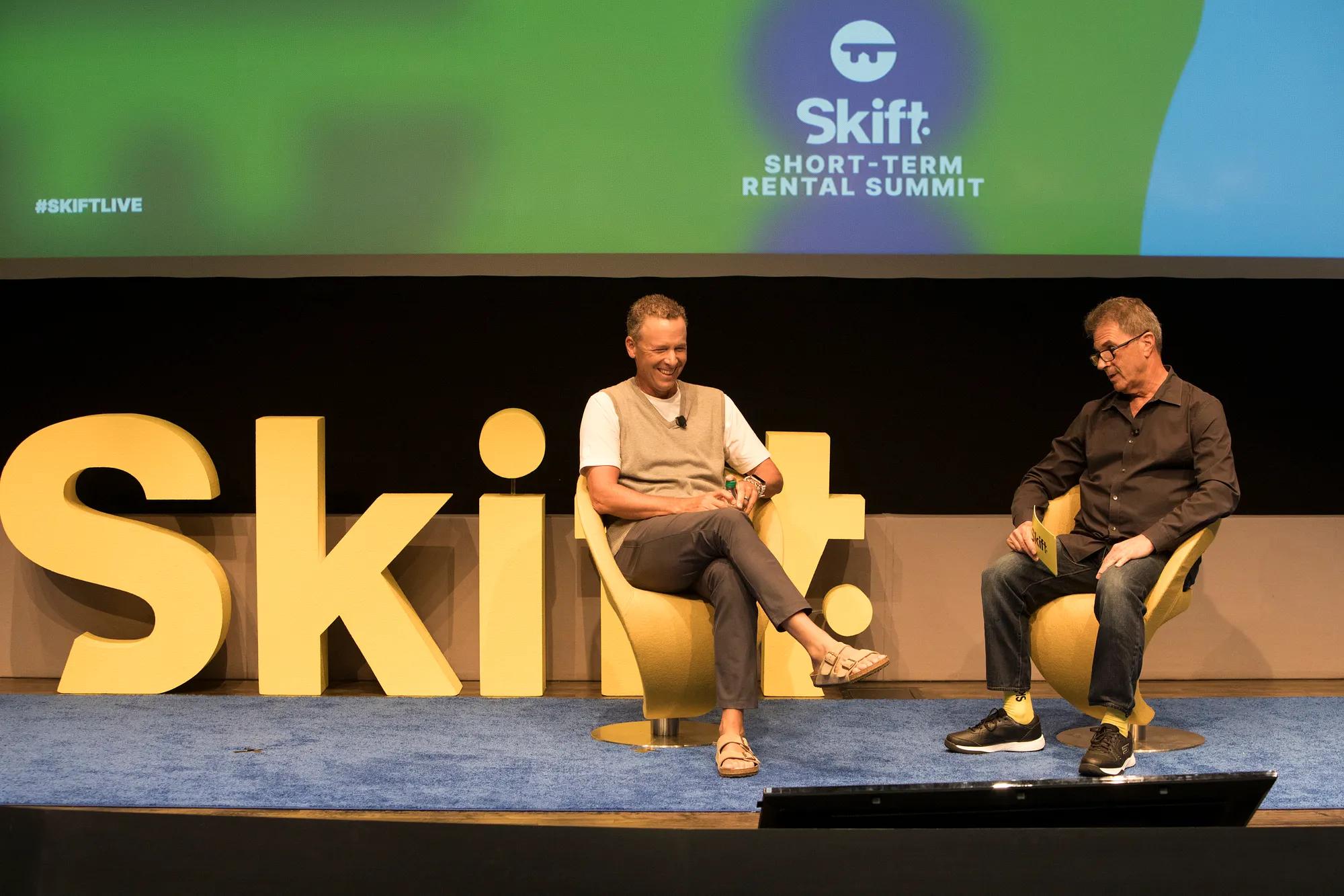 Two men converse on stage at the Skift Short-Term Rental Summit, flanked by large yellow "Skift" letters and event branding on a screen.​​​​‌﻿‍﻿​‍​‍‌‍﻿﻿‌﻿​‍‌‍‍‌‌‍‌﻿‌‍‍‌‌‍﻿‍​‍​‍​﻿‍‍​‍​‍‌﻿​﻿‌‍​‌‌‍﻿‍‌‍‍‌‌﻿‌​‌﻿‍‌​‍﻿‍‌‍‍‌‌‍﻿﻿​‍​‍​‍﻿​​‍​‍‌‍‍​‌﻿​‍‌‍‌‌‌‍‌‍​‍​‍​﻿‍‍​‍​‍​‍﻿﻿‌﻿​﻿‌﻿‌​‌﻿‌‌‌‍‌​‌‍‍‌‌‍﻿﻿​‍﻿﻿‌‍‍‌‌‍﻿‍‌﻿‌​‌‍‌‌‌‍﻿‍‌﻿‌​​‍﻿﻿‌‍‌‌‌‍‌​‌‍‍‌‌﻿‌​​‍﻿﻿‌‍﻿‌‌‍﻿﻿‌‍‌​‌‍‌‌​﻿﻿‌‌﻿​​‌﻿​‍‌‍‌‌‌﻿​﻿‌‍‌‌‌‍﻿‍‌﻿‌​‌‍​‌‌﻿‌​‌‍‍‌‌‍﻿﻿‌‍﻿‍​﻿‍﻿‌‍‍‌‌‍‌​​﻿﻿‌‌‍‌‌‌‍‌​​﻿‌﻿​﻿​‌​﻿​‌‌‍‌‍​﻿​‍‌‍‌​​‍﻿‌‌‍​‌​﻿‌‌​﻿​﻿​﻿‌​​‍﻿‌​﻿‌​‌‍‌​​﻿‍‌​﻿‍​​‍﻿‌​﻿‍‌​﻿‍‌‌‍​‍​﻿‍​​‍﻿‌​﻿‌‍‌‍​‌​﻿​﻿‌‍‌‍‌‍‌​​﻿‌‌​﻿‍‌​﻿​﻿‌‍​‍‌‍​‍‌‍‌‍‌‍​﻿​﻿‍﻿‌﻿‌​‌﻿‍‌‌﻿​​‌‍‌‌​﻿﻿‌‌﻿​​‌‍﻿﻿‌﻿​﻿‌﻿‌​​﻿‍﻿‌﻿​​‌‍​‌‌﻿‌​‌‍‍​​﻿﻿‌‌‍​﻿‌‍﻿﻿‌﻿‌‍‌‍‌‌‌﻿​‍‌​‍‌‌‍﻿‌‌‍​‌‌‍‌﻿‌‍‌‌​‍﻿‍‌‍​‌‌‍﻿​‌﻿‌​​﻿﻿﻿‌‍​‍‌‍​‌‌﻿​﻿‌‍‌‌‌‌‌‌‌﻿​‍‌‍﻿​​﻿﻿‌​‍‌‌​﻿​‍‌​‌‍‌﻿​﻿‌﻿‌​‌﻿‌‌‌‍‌​‌‍‍‌‌‍﻿﻿​‍‌‍‌‍‍‌‌‍‌​​﻿﻿‌‌‍‌‌‌‍‌​​﻿‌﻿​﻿​‌​﻿​‌‌‍‌‍​﻿​‍‌‍‌​​‍﻿‌‌‍​‌​﻿‌‌​﻿​﻿​﻿‌​​‍﻿‌​﻿‌​‌‍‌​​﻿‍‌​﻿‍​​‍﻿‌​﻿‍‌​﻿‍‌‌‍​‍​﻿‍​​‍﻿‌​﻿‌‍‌‍​‌​﻿​﻿‌‍‌‍‌‍‌​​﻿‌‌​﻿‍‌​﻿​﻿‌‍​‍‌‍​‍‌‍‌‍‌‍​﻿​‍‌‍‌﻿‌​‌﻿‍‌‌﻿​​‌‍‌‌​﻿﻿‌‌﻿​​‌‍﻿﻿‌﻿​﻿‌﻿‌​​‍‌‍‌﻿​​‌‍​‌‌﻿‌​‌‍‍​​﻿﻿‌‌‍​﻿‌‍﻿﻿‌﻿‌‍‌‍‌‌‌﻿​‍‌​‍‌‌‍﻿‌‌‍​‌‌‍‌﻿‌‍‌‌​‍﻿‍‌‍​‌‌‍﻿​‌﻿‌​​‍‌‍‌﻿​​‌‍‌‌‌﻿​‍‌﻿​﻿‌﻿​​‌‍‌‌‌‍​﻿‌﻿‌​‌‍‍‌‌﻿‌‍‌‍‌‌​﻿﻿‌‌﻿​​‌﻿‌‌‌‍​‍‌‍﻿​‌‍‍‌‌﻿​﻿‌‍‍​‌‍‌‌‌‍‌​​‍​‍‌﻿﻿‌