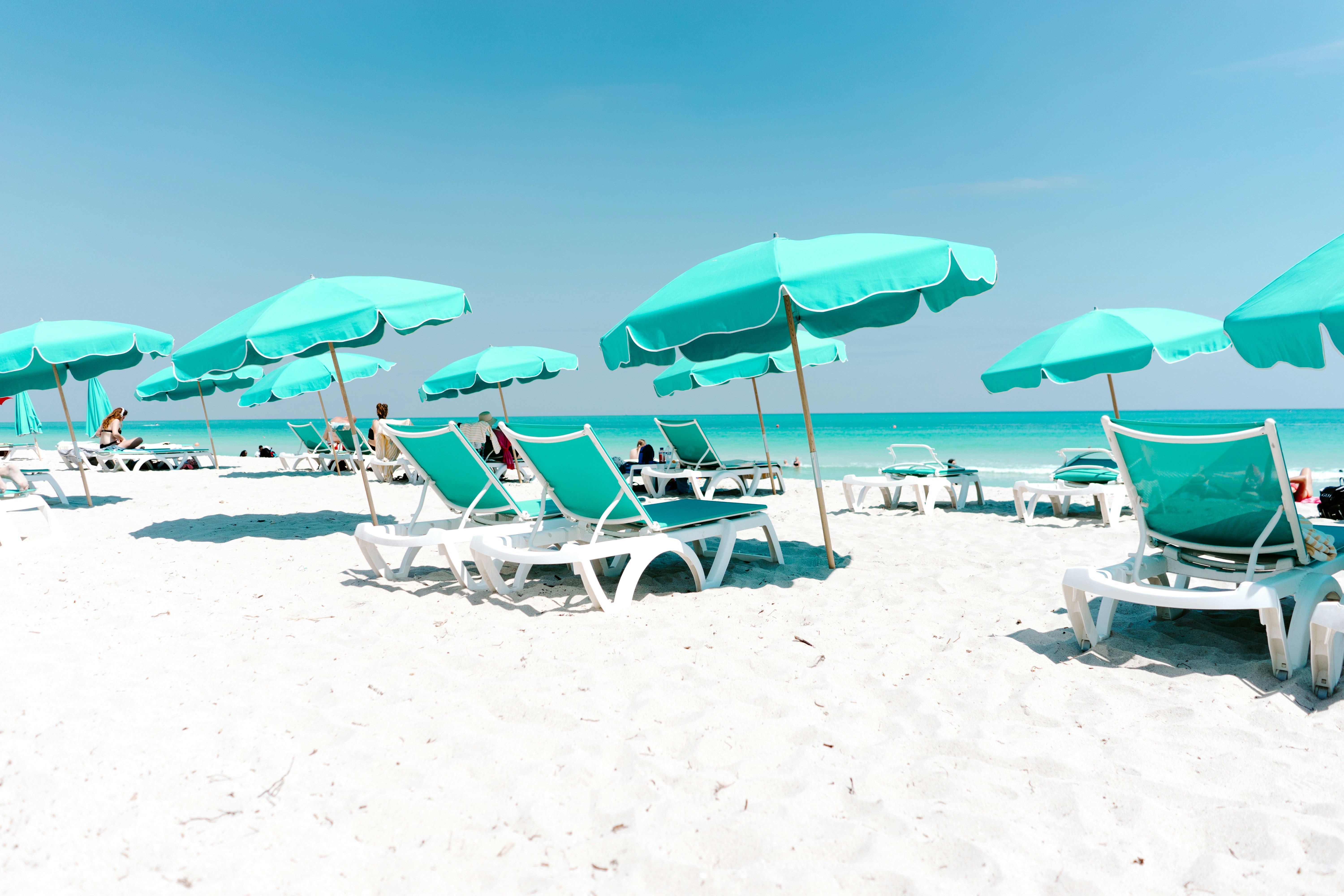 A white sand beach with rows of teal umbrellas and lounge chairs by the ocean.​​​​‌﻿‍﻿​‍​‍‌‍﻿﻿‌﻿​‍‌‍‍‌‌‍‌﻿‌‍‍‌‌‍﻿‍​‍​‍​﻿‍‍​‍​‍‌﻿​﻿‌‍​‌‌‍﻿‍‌‍‍‌‌﻿‌​‌﻿‍‌​‍﻿‍‌‍‍‌‌‍﻿﻿​‍​‍​‍﻿​​‍​‍‌‍‍​‌﻿​‍‌‍‌‌‌‍‌‍​‍​‍​﻿‍‍​‍​‍​‍﻿﻿‌﻿​﻿‌﻿‌​‌﻿‌‌‌‍‌​‌‍‍‌‌‍﻿﻿​‍﻿﻿‌‍‍‌‌‍﻿‍‌﻿‌​‌‍‌‌‌‍﻿‍‌﻿‌​​‍﻿﻿‌‍‌‌‌‍‌​‌‍‍‌‌﻿‌​​‍﻿﻿‌‍﻿‌‌‍﻿﻿‌‍‌​‌‍‌‌​﻿﻿‌‌﻿​​‌﻿​‍‌‍‌‌‌﻿​﻿‌‍‌‌‌‍﻿‍‌﻿‌​‌‍​‌‌﻿‌​‌‍‍‌‌‍﻿﻿‌‍﻿‍​﻿‍﻿‌‍‍‌‌‍‌​​﻿﻿‌‌‍‌‌​﻿‍‌‌‍​﻿‌‍​‌‌‍‌‍​﻿‌‍​﻿‌‌​﻿‌​​‍﻿‌‌‍​﻿​﻿​​‌‍‌‌​﻿​﻿​‍﻿‌​﻿‌​‌‍​‌​﻿‌​​﻿​‌​‍﻿‌​﻿‍‌‌‍‌‌‌‍​﻿‌‍‌‌​‍﻿‌​﻿‍‌‌‍​‍​﻿‍‌‌‍‌​‌‍​﻿​﻿‌​​﻿​‌​﻿​﻿​﻿‌‍​﻿‌﻿​﻿‌‌‌‍​﻿​﻿‍﻿‌﻿‌​‌﻿‍‌‌﻿​​‌‍‌‌​﻿﻿‌‌﻿​​‌‍﻿﻿‌﻿​﻿‌﻿‌​​﻿‍﻿‌﻿​​‌‍​‌‌﻿‌​‌‍‍​​﻿﻿‌‌‍​﻿‌‍﻿﻿‌﻿‌‍‌‍‌‌‌﻿​‍‌​‍‌‌‍﻿‌‌‍​‌‌‍‌﻿‌‍‌‌​‍﻿‍‌‍​‌‌‍﻿​‌﻿‌​​﻿﻿﻿‌‍​‍‌‍​‌‌﻿​﻿‌‍‌‌‌‌‌‌‌﻿​‍‌‍﻿​​﻿﻿‌​‍‌‌​﻿​‍‌​‌‍‌﻿​﻿‌﻿‌​‌﻿‌‌‌‍‌​‌‍‍‌‌‍﻿﻿​‍‌‍‌‍‍‌‌‍‌​​﻿﻿‌‌‍‌‌​﻿‍‌‌‍​﻿‌‍​‌‌‍‌‍​﻿‌‍​﻿‌‌​﻿‌​​‍﻿‌‌‍​﻿​﻿​​‌‍‌‌​﻿​﻿​‍﻿‌​﻿‌​‌‍​‌​﻿‌​​﻿​‌​‍﻿‌​﻿‍‌‌‍‌‌‌‍​﻿‌‍‌‌​‍﻿‌​﻿‍‌‌‍​‍​﻿‍‌‌‍‌​‌‍​﻿​﻿‌​​﻿​‌​﻿​﻿​﻿‌‍​﻿‌﻿​﻿‌‌‌‍​﻿​‍‌‍‌﻿‌​‌﻿‍‌‌﻿​​‌‍‌‌​﻿﻿‌‌﻿​​‌‍﻿﻿‌﻿​﻿‌﻿‌​​‍‌‍‌﻿​​‌‍​‌‌﻿‌​‌‍‍​​﻿﻿‌‌‍​﻿‌‍﻿﻿‌﻿‌‍‌‍‌‌‌﻿​‍‌​‍‌‌‍﻿‌‌‍​‌‌‍‌﻿‌‍‌‌​‍﻿‍‌‍​‌‌‍﻿​‌﻿‌​​‍‌‍‌﻿​​‌‍‌‌‌﻿​‍‌﻿​﻿‌﻿​​‌‍‌‌‌‍​﻿‌﻿‌​‌‍‍‌‌﻿‌‍‌‍‌‌​﻿﻿‌‌﻿​​‌﻿‌‌‌‍​‍‌‍﻿​‌‍‍‌‌﻿​﻿‌‍‍​‌‍‌‌‌‍‌​​‍​‍‌﻿﻿‌