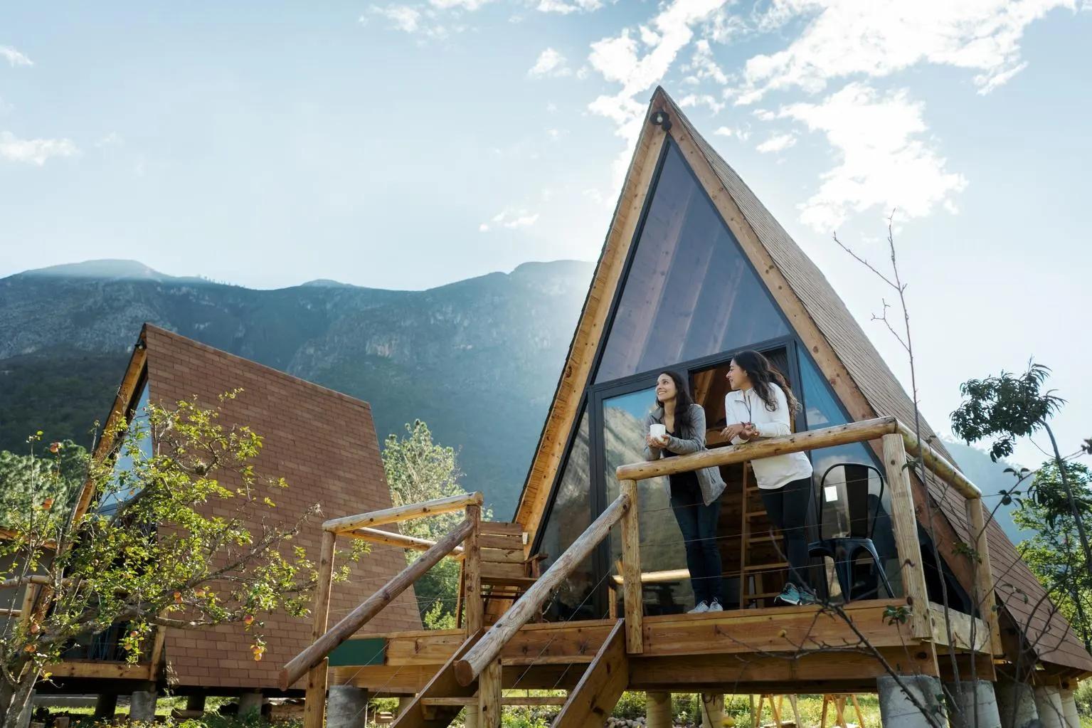 Two women stand on the balcony of a modern A-frame cabin with mountains in the background.​​​​‌﻿‍﻿​‍​‍‌‍﻿﻿‌﻿​‍‌‍‍‌‌‍‌﻿‌‍‍‌‌‍﻿‍​‍​‍​﻿‍‍​‍​‍‌﻿​﻿‌‍​‌‌‍﻿‍‌‍‍‌‌﻿‌​‌﻿‍‌​‍﻿‍‌‍‍‌‌‍﻿﻿​‍​‍​‍﻿​​‍​‍‌‍‍​‌﻿​‍‌‍‌‌‌‍‌‍​‍​‍​﻿‍‍​‍​‍​‍﻿﻿‌﻿​﻿‌﻿‌​‌﻿‌‌‌‍‌​‌‍‍‌‌‍﻿﻿​‍﻿﻿‌‍‍‌‌‍﻿‍‌﻿‌​‌‍‌‌‌‍﻿‍‌﻿‌​​‍﻿﻿‌‍‌‌‌‍‌​‌‍‍‌‌﻿‌​​‍﻿﻿‌‍﻿‌‌‍﻿﻿‌‍‌​‌‍‌‌​﻿﻿‌‌﻿​​‌﻿​‍‌‍‌‌‌﻿​﻿‌‍‌‌‌‍﻿‍‌﻿‌​‌‍​‌‌﻿‌​‌‍‍‌‌‍﻿﻿‌‍﻿‍​﻿‍﻿‌‍‍‌‌‍‌​​﻿﻿‌‌‍‌​​﻿‌​​﻿‌﻿‌‍‌​​﻿‍​​﻿​﻿‌‍​‌​﻿‌​​‍﻿‌‌‍‌​​﻿‌‍​﻿​﻿​﻿​‍​‍﻿‌​﻿‌​​﻿‌​‌‍​‌​﻿‌﻿​‍﻿‌‌‍​‍​﻿‌﻿​﻿‍‌‌‍‌‌​‍﻿‌​﻿‍‌​﻿‌​​﻿​﻿‌‍​‌​﻿​‌‌‍‌​​﻿​​​﻿‌‍​﻿‍‌‌‍​‌​﻿​‌‌‍​‍​﻿‍﻿‌﻿‌​‌﻿‍‌‌﻿​​‌‍‌‌​﻿﻿‌‌﻿​​‌‍﻿﻿‌﻿​﻿‌﻿‌​​﻿‍﻿‌﻿​​‌‍​‌‌﻿‌​‌‍‍​​﻿﻿‌‌‍​﻿‌‍﻿﻿‌﻿‌‍‌‍‌‌‌﻿​‍‌​‍‌‌‍﻿‌‌‍​‌‌‍‌﻿‌‍‌‌​‍﻿‍‌‍​‌‌‍﻿​‌﻿‌​​﻿﻿﻿‌‍​‍‌‍​‌‌﻿​﻿‌‍‌‌‌‌‌‌‌﻿​‍‌‍﻿​​﻿﻿‌​‍‌‌​﻿​‍‌​‌‍‌﻿​﻿‌﻿‌​‌﻿‌‌‌‍‌​‌‍‍‌‌‍﻿﻿​‍‌‍‌‍‍‌‌‍‌​​﻿﻿‌‌‍‌​​﻿‌​​﻿‌﻿‌‍‌​​﻿‍​​﻿​﻿‌‍​‌​﻿‌​​‍﻿‌‌‍‌​​﻿‌‍​﻿​﻿​﻿​‍​‍﻿‌​﻿‌​​﻿‌​‌‍​‌​﻿‌﻿​‍﻿‌‌‍​‍​﻿‌﻿​﻿‍‌‌‍‌‌​‍﻿‌​﻿‍‌​﻿‌​​﻿​﻿‌‍​‌​﻿​‌‌‍‌​​﻿​​​﻿‌‍​﻿‍‌‌‍​‌​﻿​‌‌‍​‍​‍‌‍‌﻿‌​‌﻿‍‌‌﻿​​‌‍‌‌​﻿﻿‌‌﻿​​‌‍﻿﻿‌﻿​﻿‌﻿‌​​‍‌‍‌﻿​​‌‍​‌‌﻿‌​‌‍‍​​﻿﻿‌‌‍​﻿‌‍﻿﻿‌﻿‌‍‌‍‌‌‌﻿​‍‌​‍‌‌‍﻿‌‌‍​‌‌‍‌﻿‌‍‌‌​‍﻿‍‌‍​‌‌‍﻿​‌﻿‌​​‍‌‍‌﻿​​‌‍‌‌‌﻿​‍‌﻿​﻿‌﻿​​‌‍‌‌‌‍​﻿‌﻿‌​‌‍‍‌‌﻿‌‍‌‍‌‌​﻿﻿‌‌﻿​​‌﻿‌‌‌‍​‍‌‍﻿​‌‍‍‌‌﻿​﻿‌‍‍​‌‍‌‌‌‍‌​​‍​‍‌﻿﻿‌