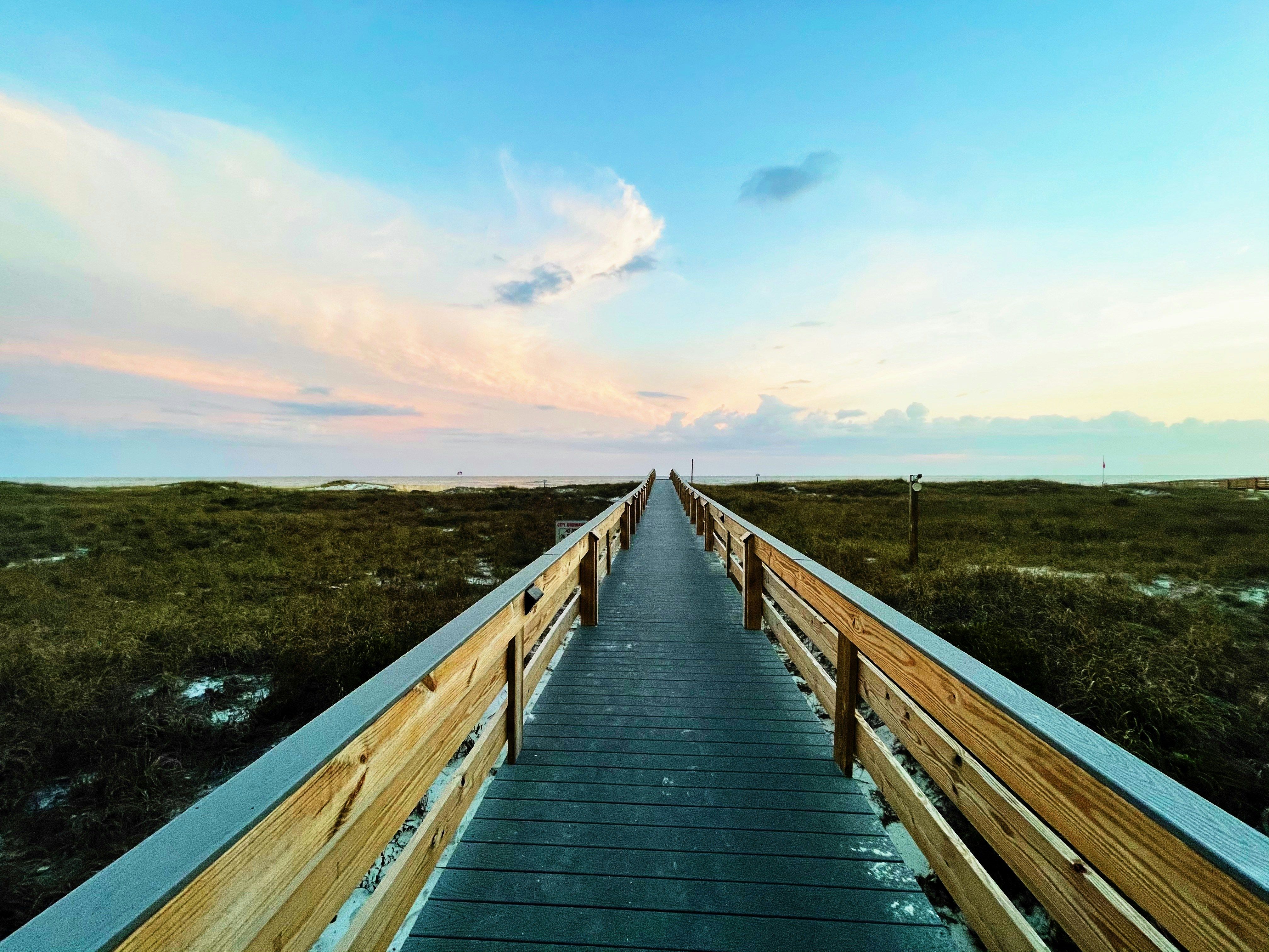Long wooden boardwalk stretching over grassy dunes towards the ocean under a pastel pink and blue sky.​​​​‌﻿‍﻿​‍​‍‌‍﻿﻿‌﻿​‍‌‍‍‌‌‍‌﻿‌‍‍‌‌‍﻿‍​‍​‍​﻿‍‍​‍​‍‌﻿​﻿‌‍​‌‌‍﻿‍‌‍‍‌‌﻿‌​‌﻿‍‌​‍﻿‍‌‍‍‌‌‍﻿﻿​‍​‍​‍﻿​​‍​‍‌‍‍​‌﻿​‍‌‍‌‌‌‍‌‍​‍​‍​﻿‍‍​‍​‍​‍﻿﻿‌﻿​﻿‌﻿‌​‌﻿‌‌‌‍‌​‌‍‍‌‌‍﻿﻿​‍﻿﻿‌‍‍‌‌‍﻿‍‌﻿‌​‌‍‌‌‌‍﻿‍‌﻿‌​​‍﻿﻿‌‍‌‌‌‍‌​‌‍‍‌‌﻿‌​​‍﻿﻿‌‍﻿‌‌‍﻿﻿‌‍‌​‌‍‌‌​﻿﻿‌‌﻿​​‌﻿​‍‌‍‌‌‌﻿​﻿‌‍‌‌‌‍﻿‍‌﻿‌​‌‍​‌‌﻿‌​‌‍‍‌‌‍﻿﻿‌‍﻿‍​﻿‍﻿‌‍‍‌‌‍‌​​﻿﻿‌​﻿‌‍​﻿‌‌​﻿‌‍​﻿‍​‌‍​﻿‌‍​﻿​﻿​﻿​﻿​​​‍﻿‌‌‍​‌​﻿‍​‌‍​﻿​﻿‍​​‍﻿‌​﻿‌​​﻿​﻿‌‍‌‍​﻿‌​​‍﻿‌‌‍​‌​﻿​﻿‌‍‌‍​﻿‌​​‍﻿‌​﻿‌﻿‌‍‌‍​﻿‌‍‌‍​‍‌‍​‍​﻿‌‌​﻿‌‍​﻿‍‌‌‍‌​​﻿​​​﻿​‍​﻿‍​​﻿‍﻿‌﻿‌​‌﻿‍‌‌﻿​​‌‍‌‌​﻿﻿‌‌﻿​​‌‍﻿﻿‌﻿​﻿‌﻿‌​​﻿‍﻿‌﻿​​‌‍​‌‌﻿‌​‌‍‍​​﻿﻿‌‌‍​﻿‌‍﻿﻿‌﻿‌‍‌‍‌‌‌﻿​‍‌​‍‌‌‍﻿‌‌‍​‌‌‍‌﻿‌‍‌‌​‍﻿‍‌‍​‌‌‍﻿​‌﻿‌​​﻿﻿﻿‌‍​‍‌‍​‌‌﻿​﻿‌‍‌‌‌‌‌‌‌﻿​‍‌‍﻿​​﻿﻿‌​‍‌‌​﻿​‍‌​‌‍‌﻿​﻿‌﻿‌​‌﻿‌‌‌‍‌​‌‍‍‌‌‍﻿﻿​‍‌‍‌‍‍‌‌‍‌​​﻿﻿‌​﻿‌‍​﻿‌‌​﻿‌‍​﻿‍​‌‍​﻿‌‍​﻿​﻿​﻿​﻿​​​‍﻿‌‌‍​‌​﻿‍​‌‍​﻿​﻿‍​​‍﻿‌​﻿‌​​﻿​﻿‌‍‌‍​﻿‌​​‍﻿‌‌‍​‌​﻿​﻿‌‍‌‍​﻿‌​​‍﻿‌​﻿‌﻿‌‍‌‍​﻿‌‍‌‍​‍‌‍​‍​﻿‌‌​﻿‌‍​﻿‍‌‌‍‌​​﻿​​​﻿​‍​﻿‍​​‍‌‍‌﻿‌​‌﻿‍‌‌﻿​​‌‍‌‌​﻿﻿‌‌﻿​​‌‍﻿﻿‌﻿​﻿‌﻿‌​​‍‌‍‌﻿​​‌‍​‌‌﻿‌​‌‍‍​​﻿﻿‌‌‍​﻿‌‍﻿﻿‌﻿‌‍‌‍‌‌‌﻿​‍‌​‍‌‌‍﻿‌‌‍​‌‌‍‌﻿‌‍‌‌​‍﻿‍‌‍​‌‌‍﻿​‌﻿‌​​‍‌‍‌﻿​​‌‍‌‌‌﻿​‍‌﻿​﻿‌﻿​​‌‍‌‌‌‍​﻿‌﻿‌​‌‍‍‌‌﻿‌‍‌‍‌‌​﻿﻿‌‌﻿​​‌﻿‌‌‌‍​‍‌‍﻿​‌‍‍‌‌﻿​﻿‌‍‍​‌‍‌‌‌‍‌​​‍​‍‌﻿﻿‌