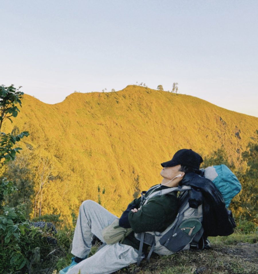 Resting against a golden ridge on a hike