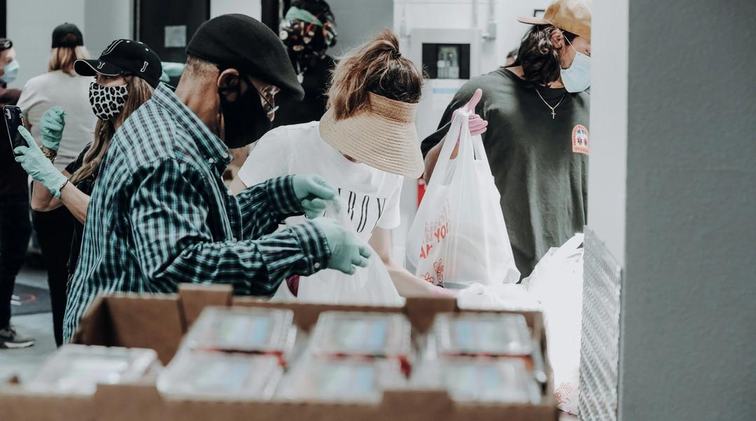 People volunteering at a food drive.